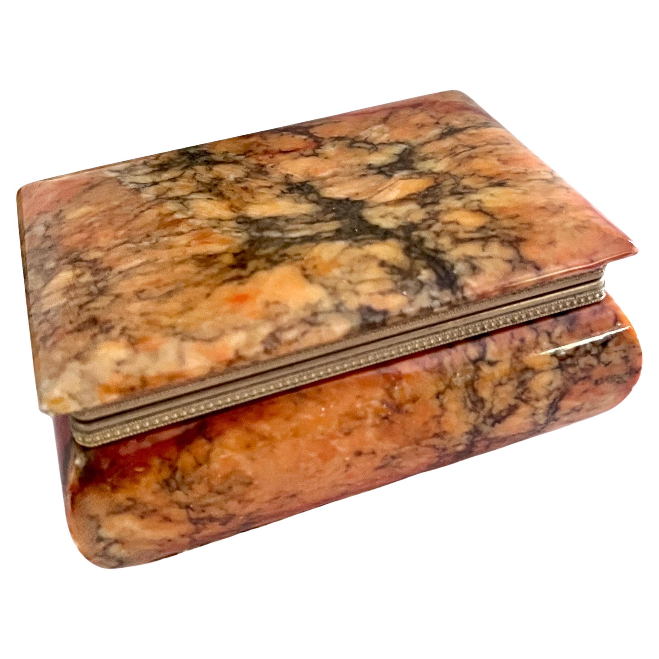 A vibrant Orange and Golden color Alabaster box with a brass trimmed closure.

The box is ideal for jewelry, decor on a cocktail table or holding office supplies on your desk or work station.

One of our favorite boxes - the color and condition is