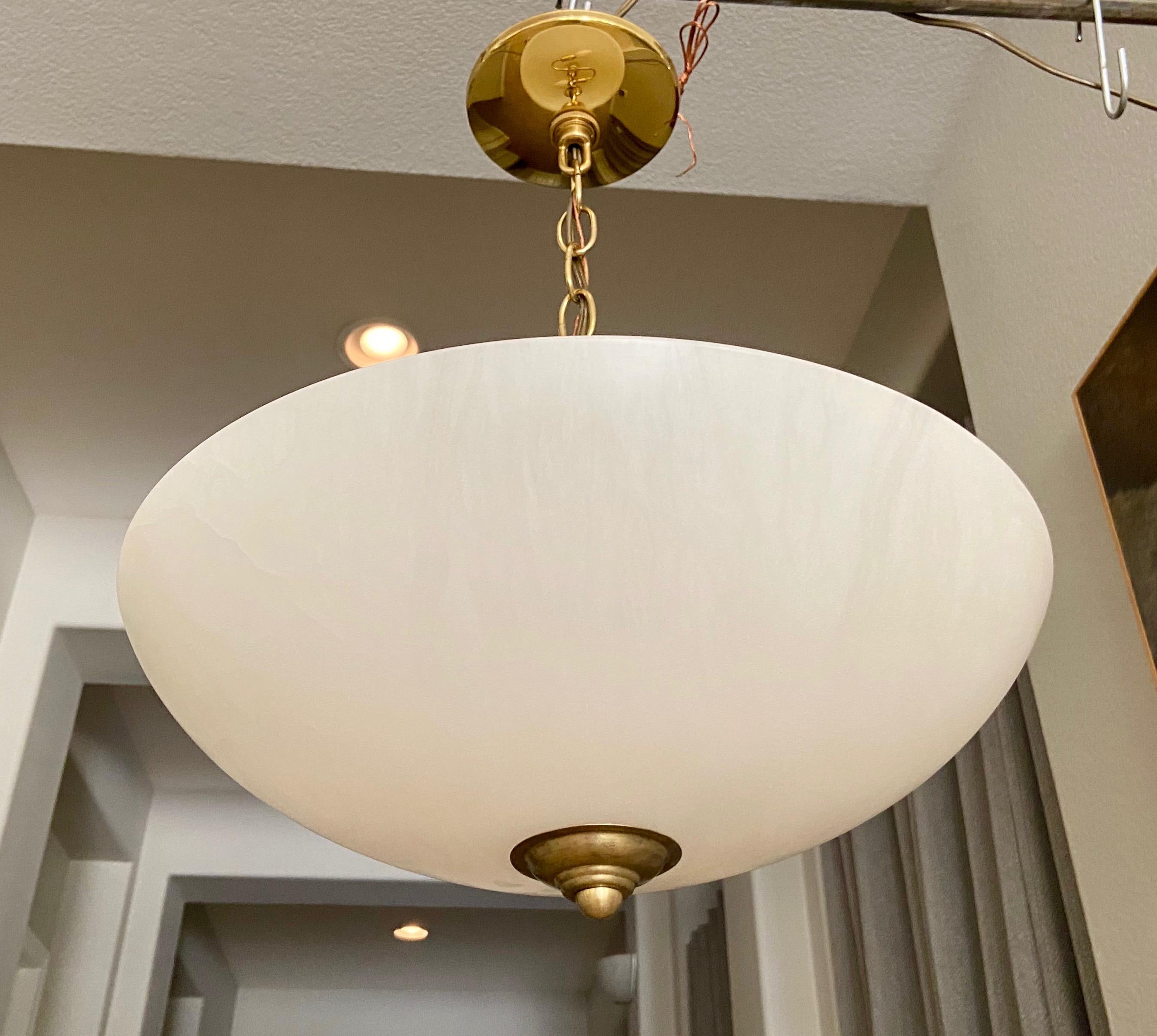 Classic style alabaster pendant or chandelier with 2 lights and brass fittings. Fixture uses two regular candelabras size 60 watt LED bulbs. Alabaster pendant is a Classic and versatile choice in lighting. Perfect for hall entry or eating