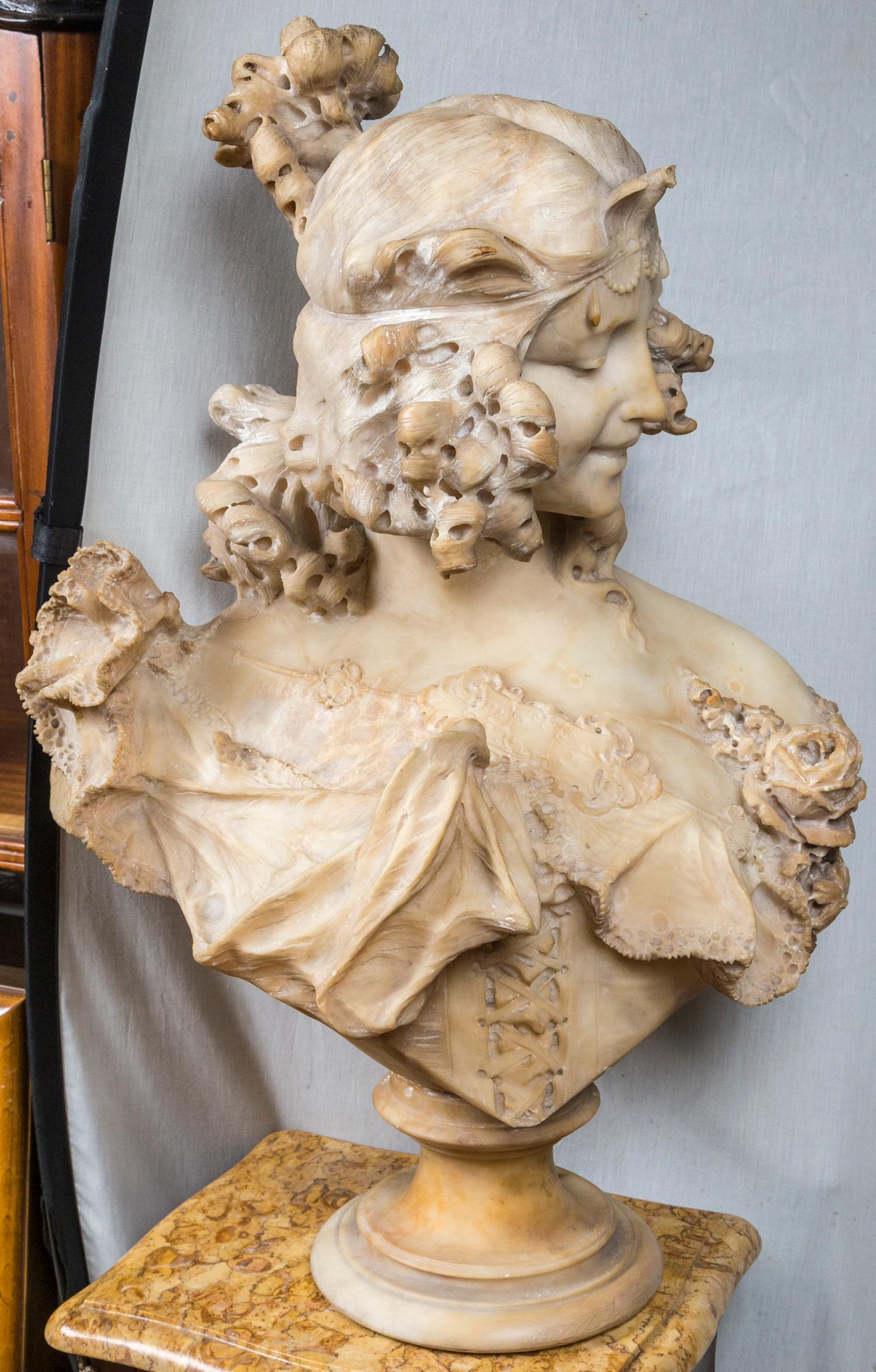 This lady has loose curls of lush hair on the sides and back. A knot of her hair sits atop her head. She wears a lace bordered gown, gathered in the center with floral adornments. The unattached base is 8 inches in diameter.