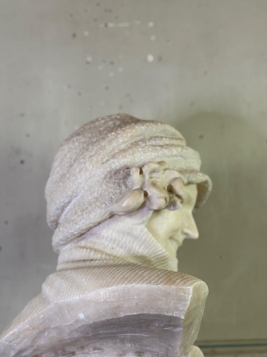 French Alabaster bust of a young girl wearing a turtleneck, signed Caloni, Italy, circa For Sale