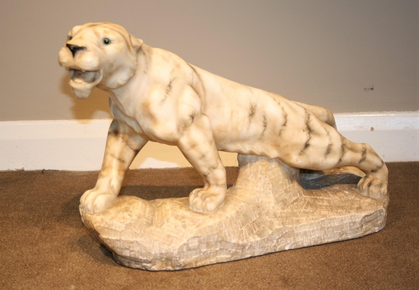 A well carved alabaster tiger signed P Ruggeri.