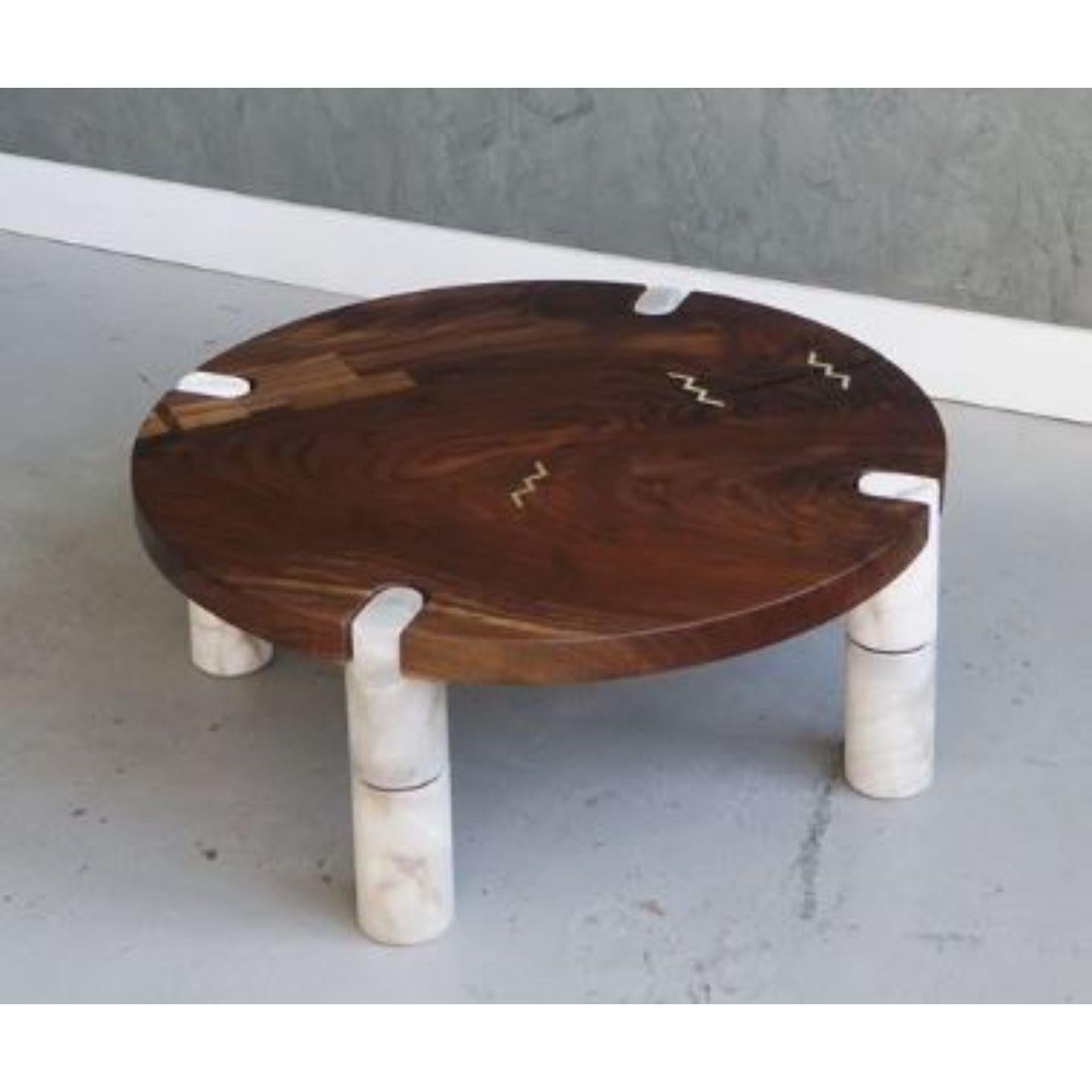 Alabaster coffee table by Swell Studio
Dimensions: D92 x W92 x H36 cm 
Material: Claro walnut hand shaped alabaster polished brass 
Also available in different materials. 


Solid wood top with notched hand shaped stone legs, custom patchwork,