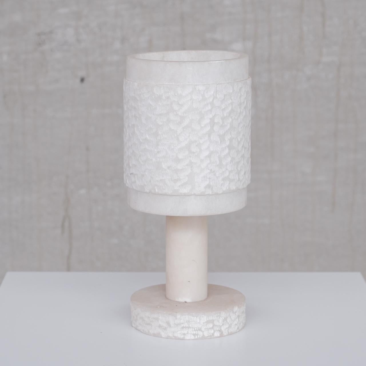 An alabaster table lamp. 

France, c1950s. 

Sourced in a cluster of seven varied style alabaster lamps. 

Price is for the single lamp. 

Some scuffs and wear commensurate with age but generally good condition. 

Since re-wired and PAT