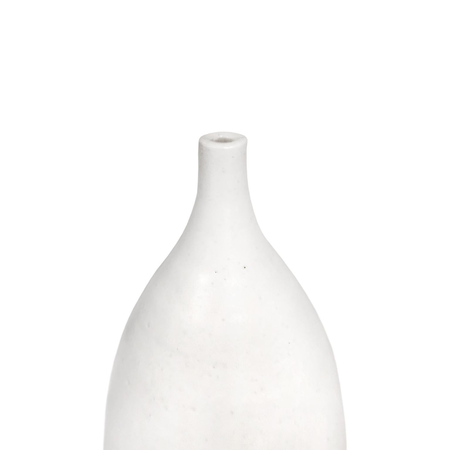 Alabaster glaze ceramic bottle #6 by Sandi Fellman, 2018. 

Veteran photographer Sandi Fellman's ceramic vessels are an exploration of a new medium. The forms, palettes, and sensuality of her photos can be found within each piece. The tactile