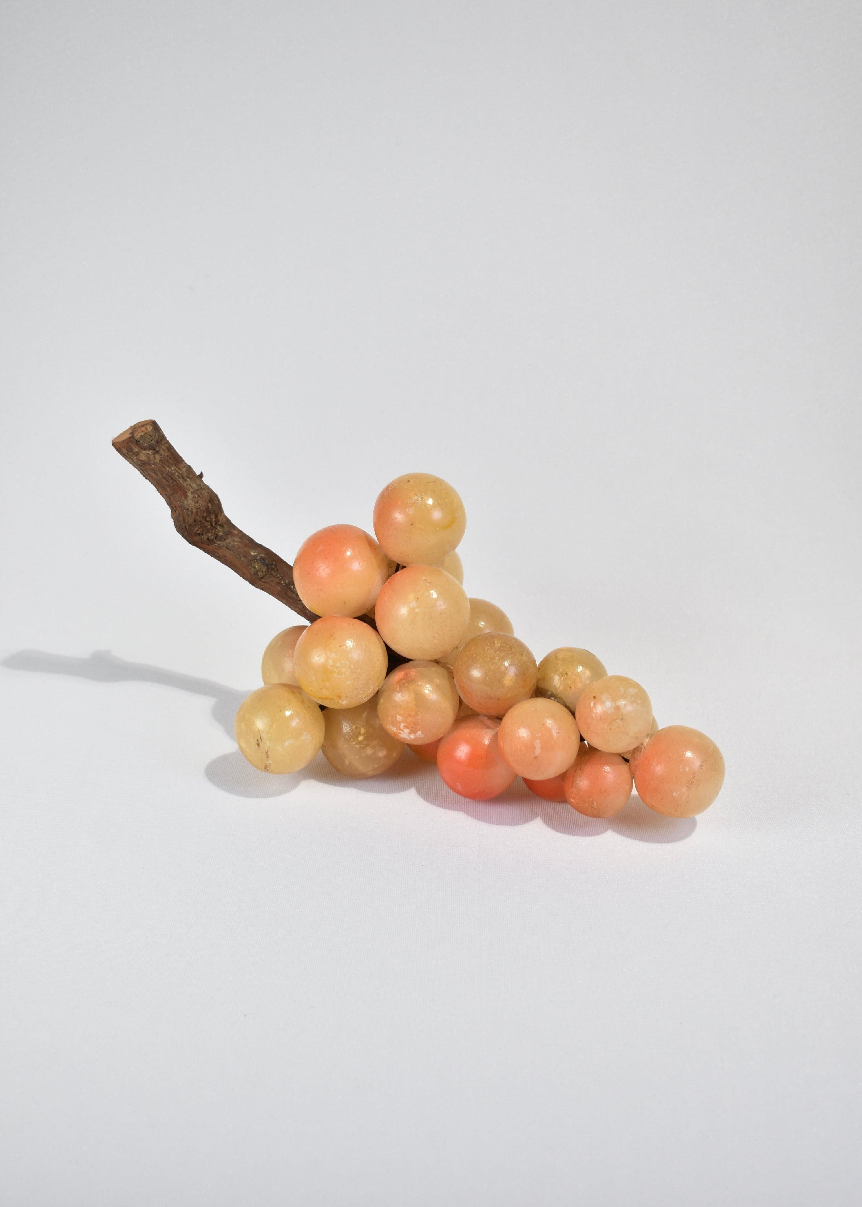 Vintage, yellow alabaster grape sculpture with orange accents and wooden stem; a beautiful coffee table accent piece. Made in Italy.