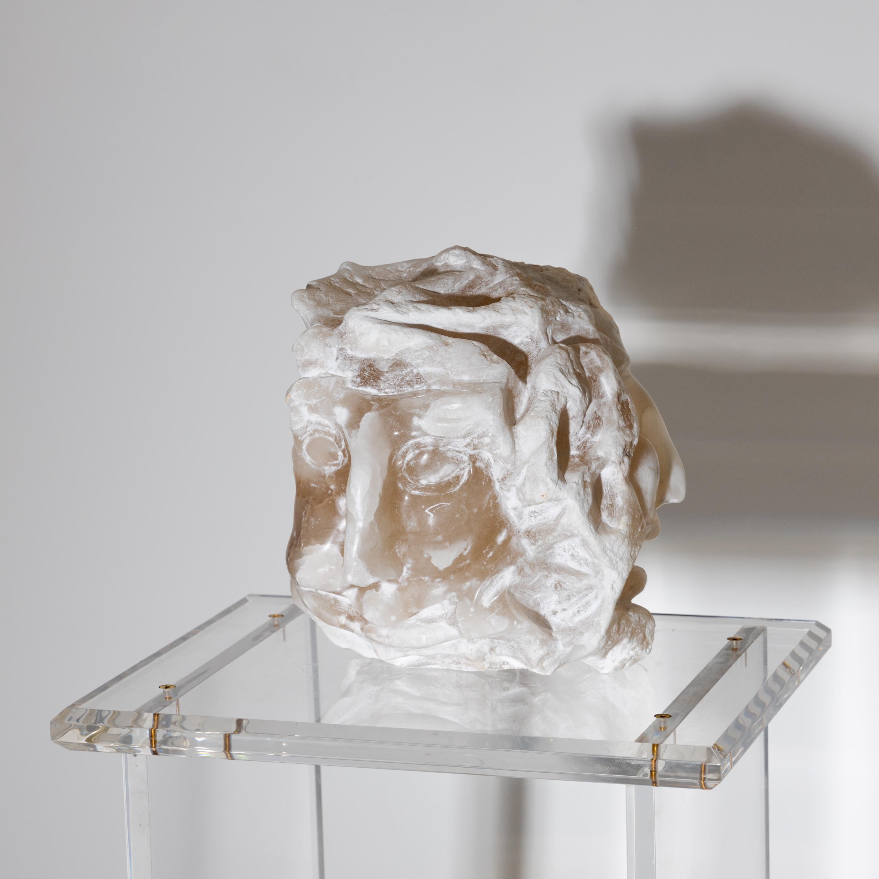 Sculpture of an abstracted head hand-carved from alabaster.