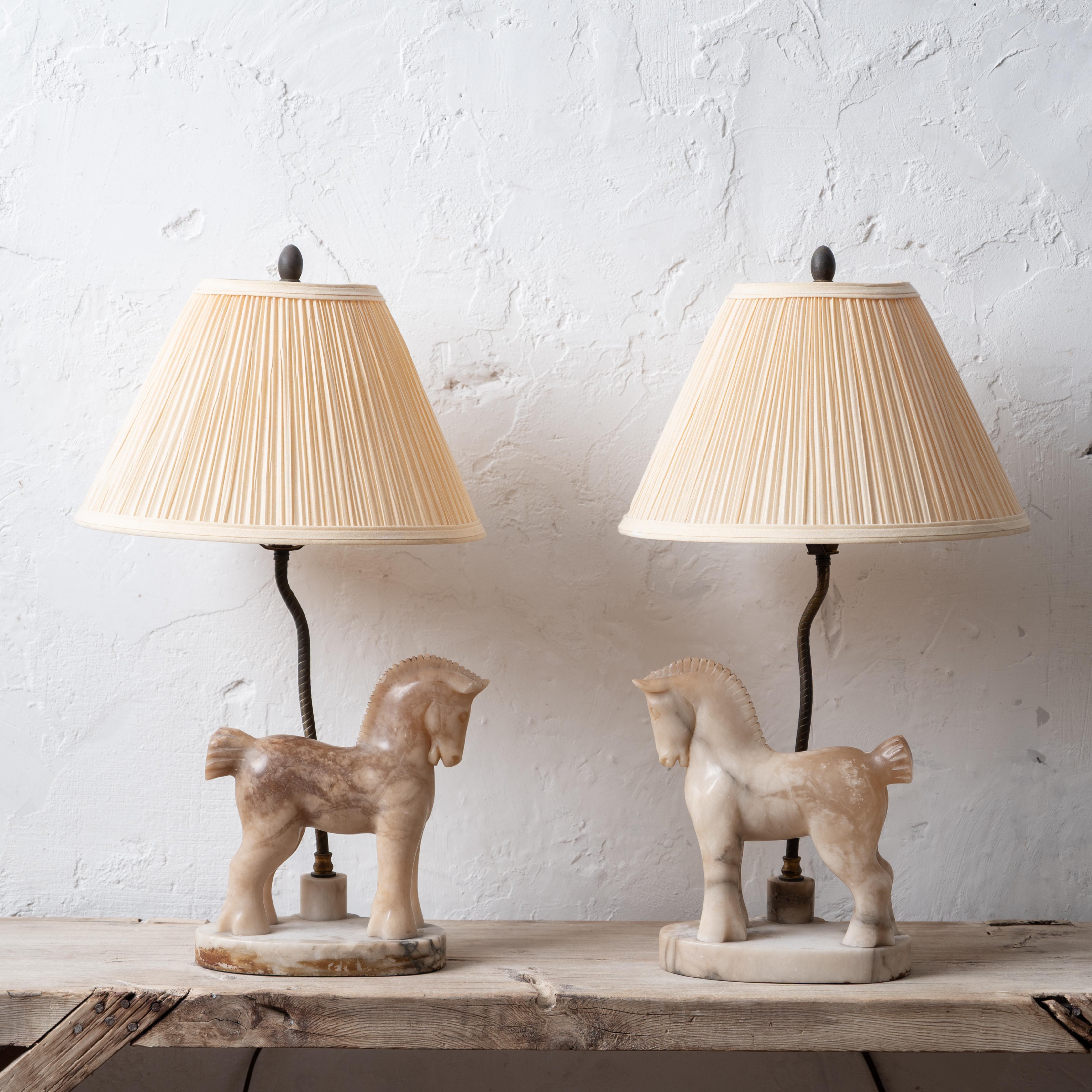 A pair of alabaster horse lamps, circa 1950.



base: 8 ½ inches wide by 5 inches deep by 9 ½ inches tall

overall: 12 inches wide by 21 inches tall



