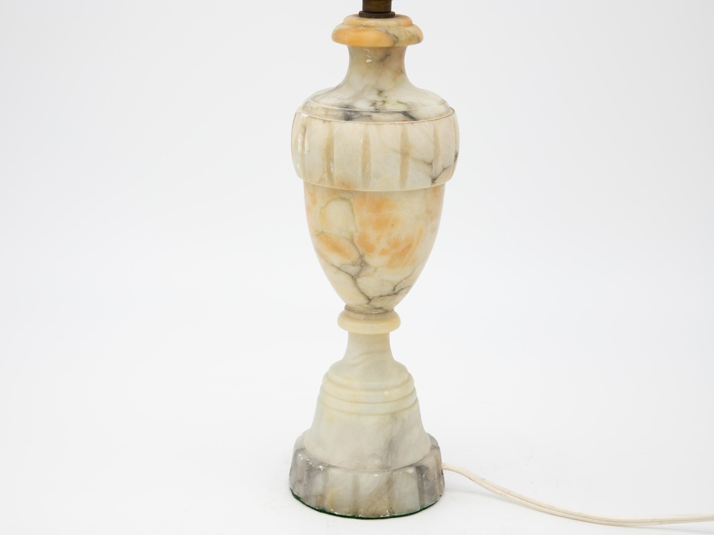 Large alabaster Neoclassical style urn lamp. Some gray coloring throughout the alabaster. Brown discoloration on the neck and body. Please see the photos. Early 20th century. Rewired. Harp and shade not included.