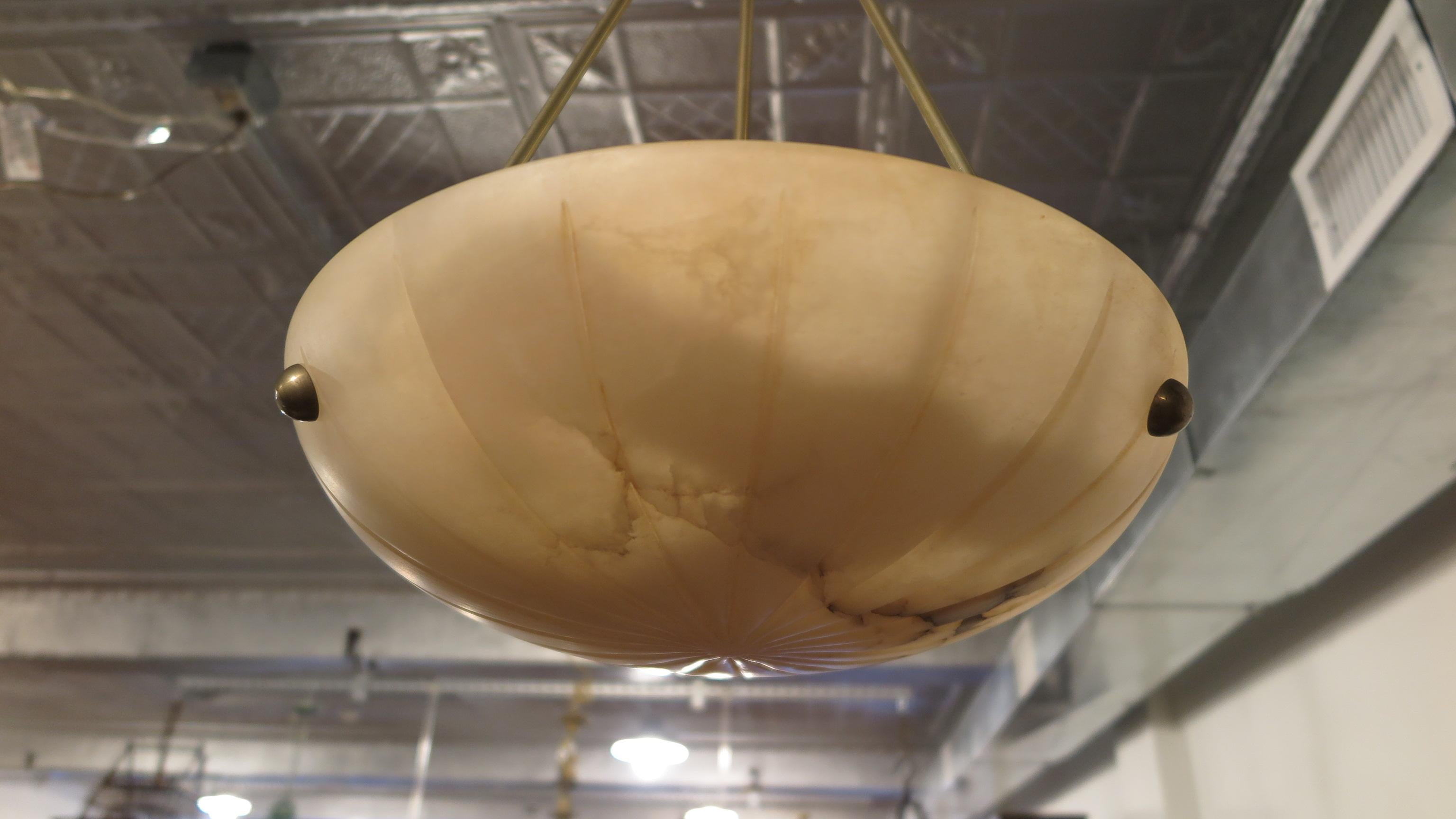Mid century Alabaster Pendant, Alabaster & Brass Pendant.  Elegantly simple alabaster inverted dome showcasing the beauty of its natural veining, suspended on three brass poles, with simple brass studs. Stunning when illuminated. Has three sockets,
