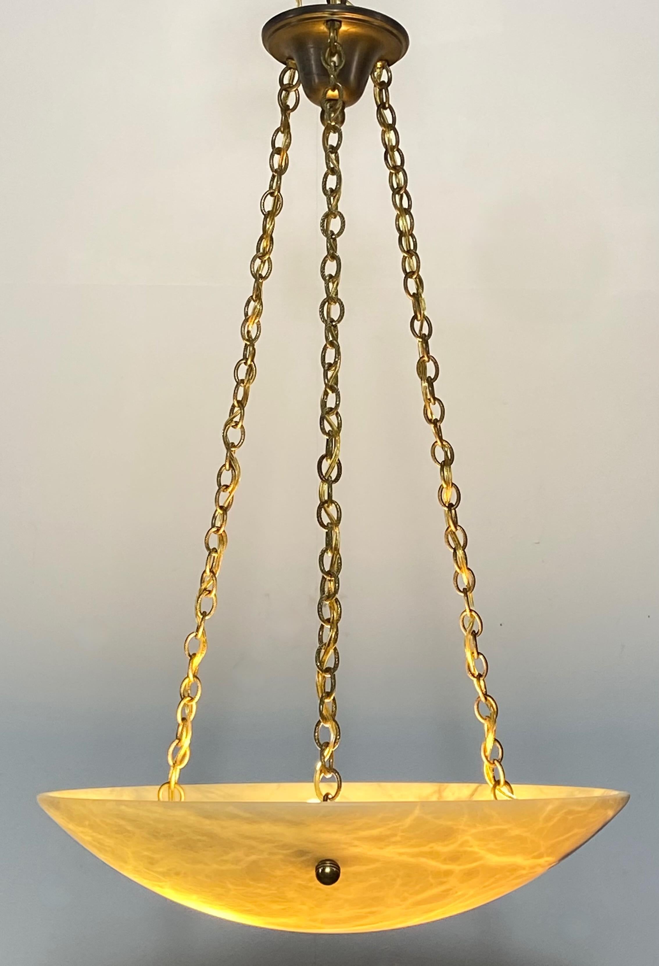 Light amber-ish color alabaster bowl shape pendant light fixture with solid brass rope style chain.
Recently re-wired and ready to install. We can adjust the the length of the drop to buyers specification if desired.
Antique alabaster bowl with