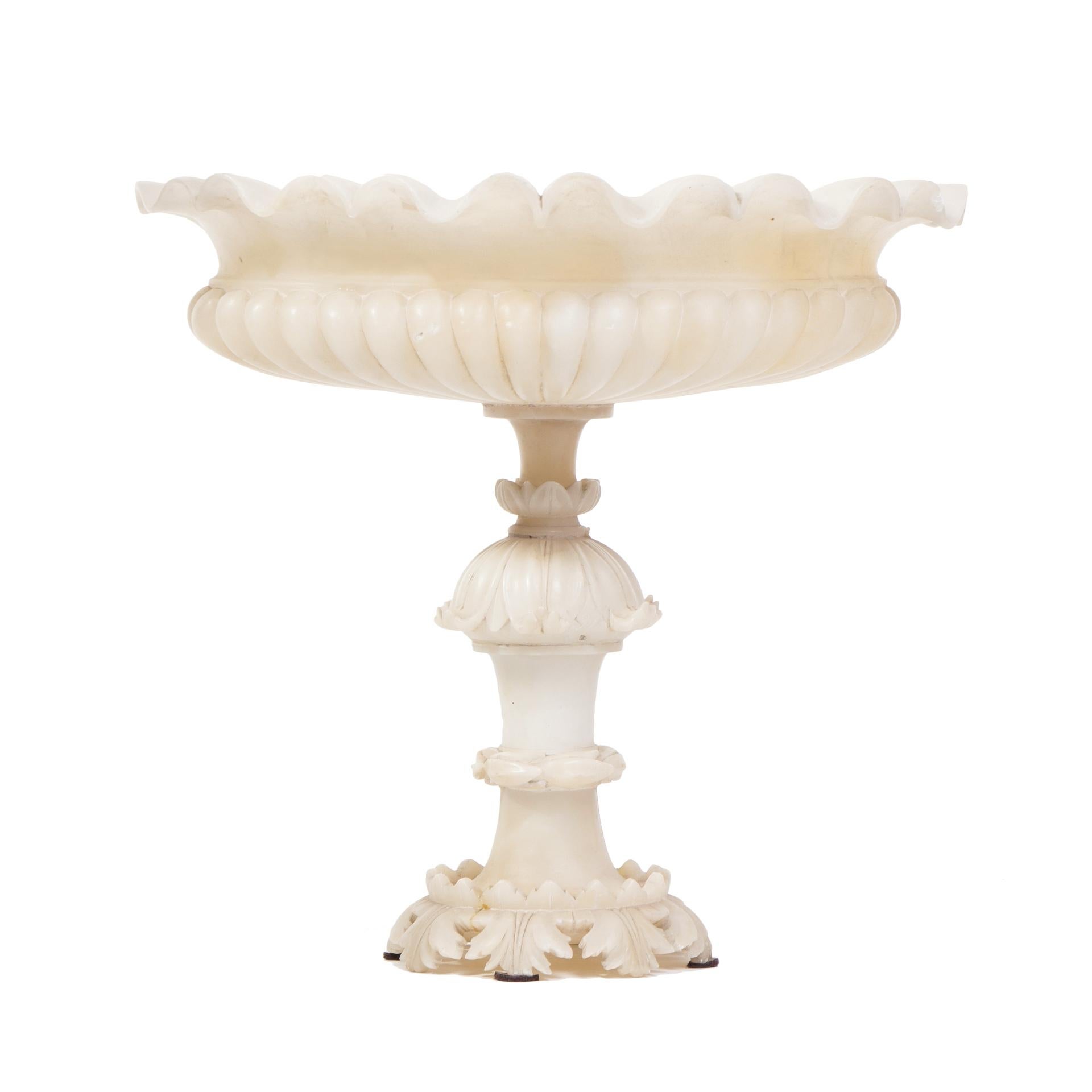This large alabaster epergne is absolutely stunning genuine piece, first half of the 19th century.

Supported by a slender and tall leg is a fine display of the Biedermeier-style craft grandeur.

Epergne was creating in the last period of
