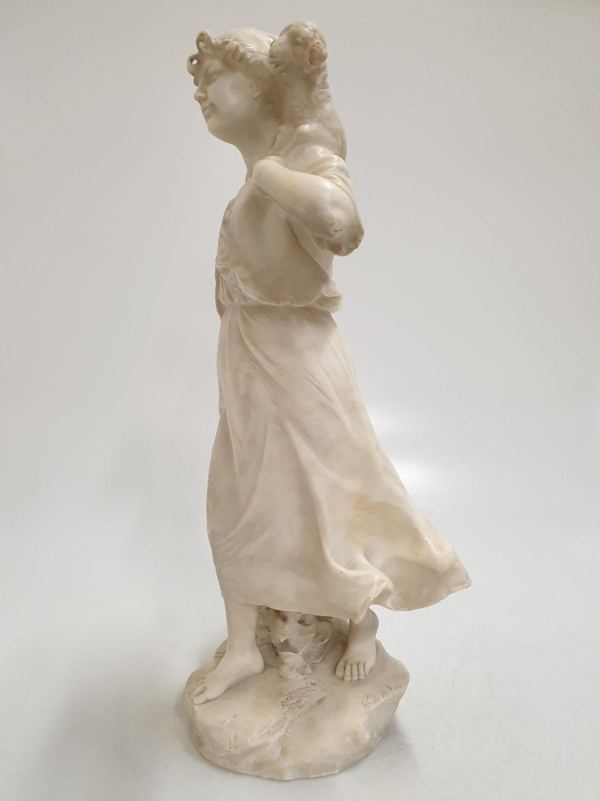 Half a meter high, alabaster sculpture
by Donatello Gabbrielli (1884-1955),
depicting a shepherdess carrying a sheep on her arms. Signed 