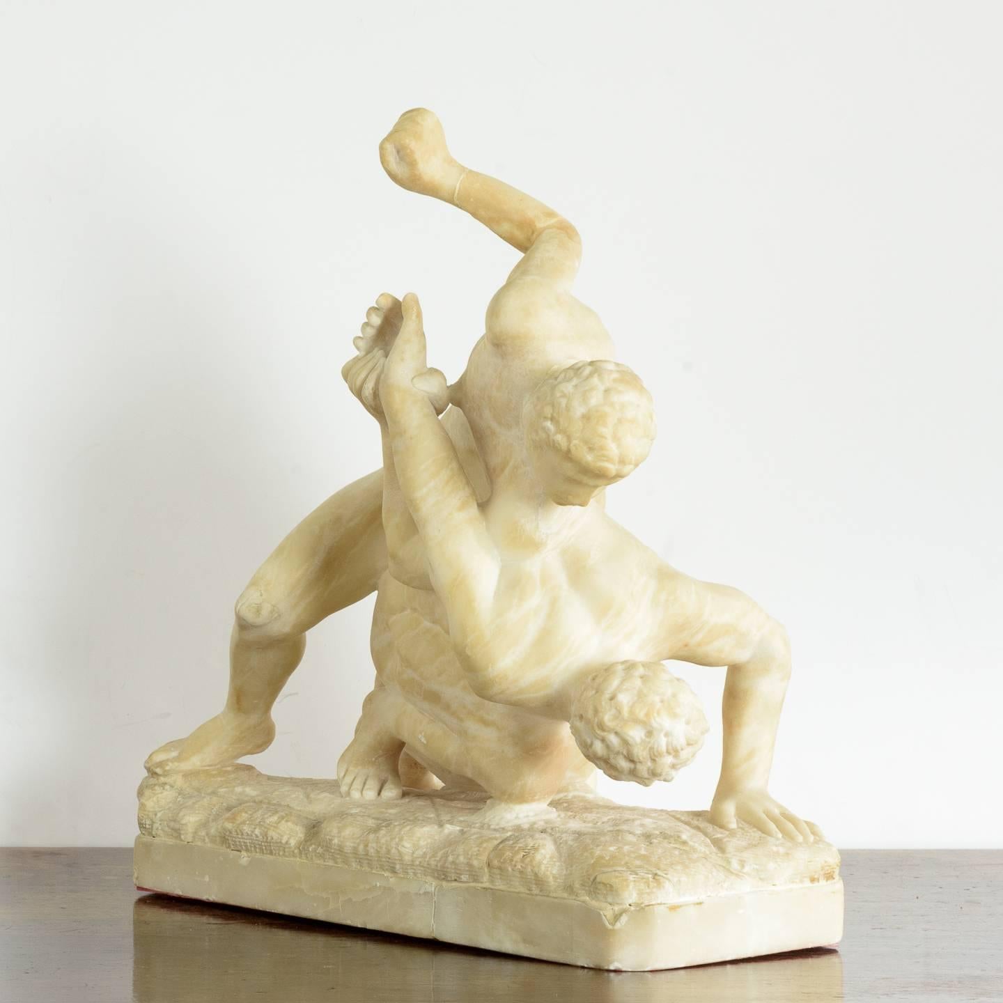 An Itlalian nineteenth century alabaster sculpture of the Uffizi Wrestlers, after the Roman bronze, on plinth base. In good condition with old repairs to the arm and neck.

The sculpture of the Uffizi Wrestlers, originally based on a lost Greek