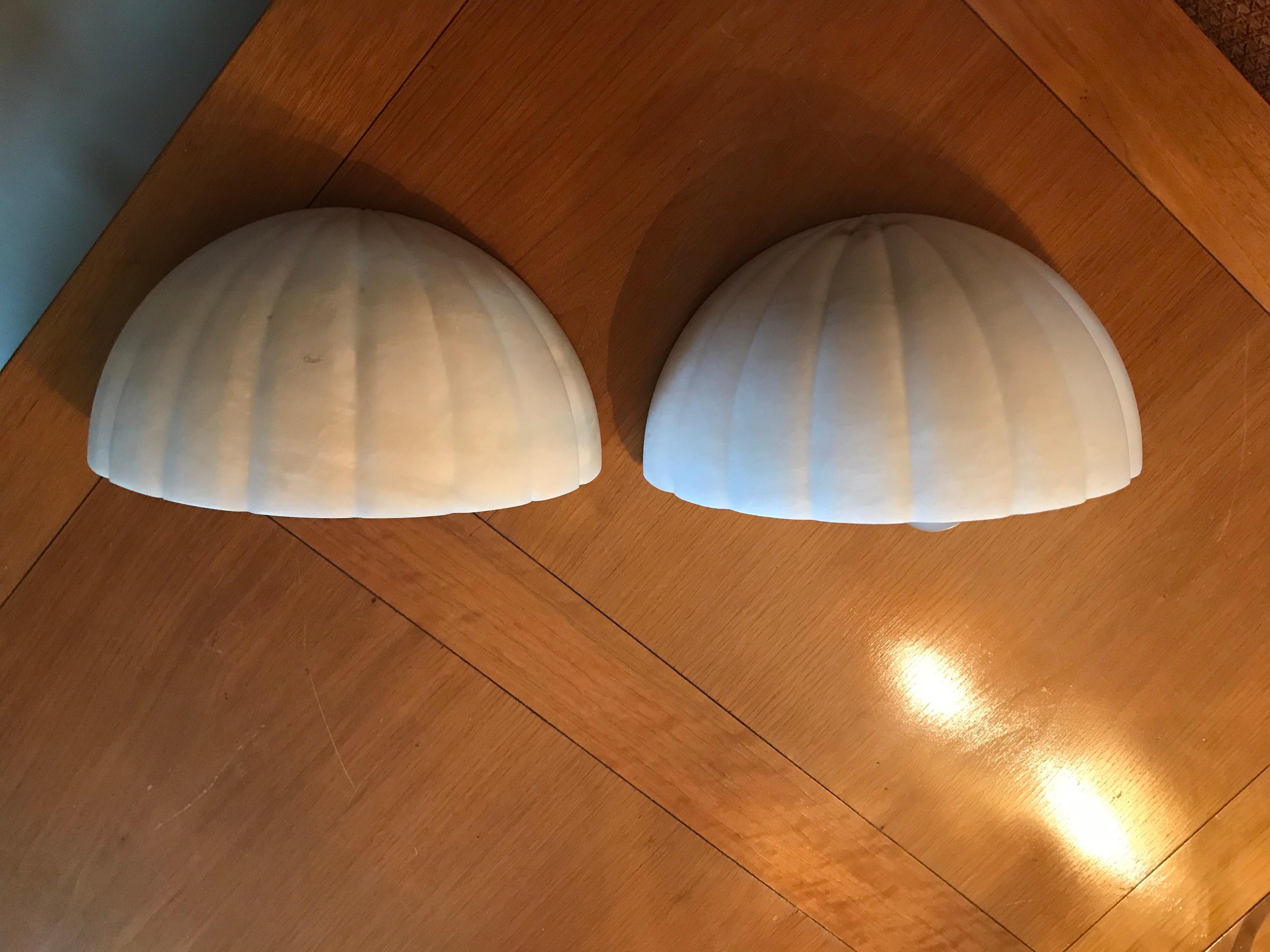 This is a pair of alabaster half moon electric sconces by Sarreid Probably from 1970s-1980s.