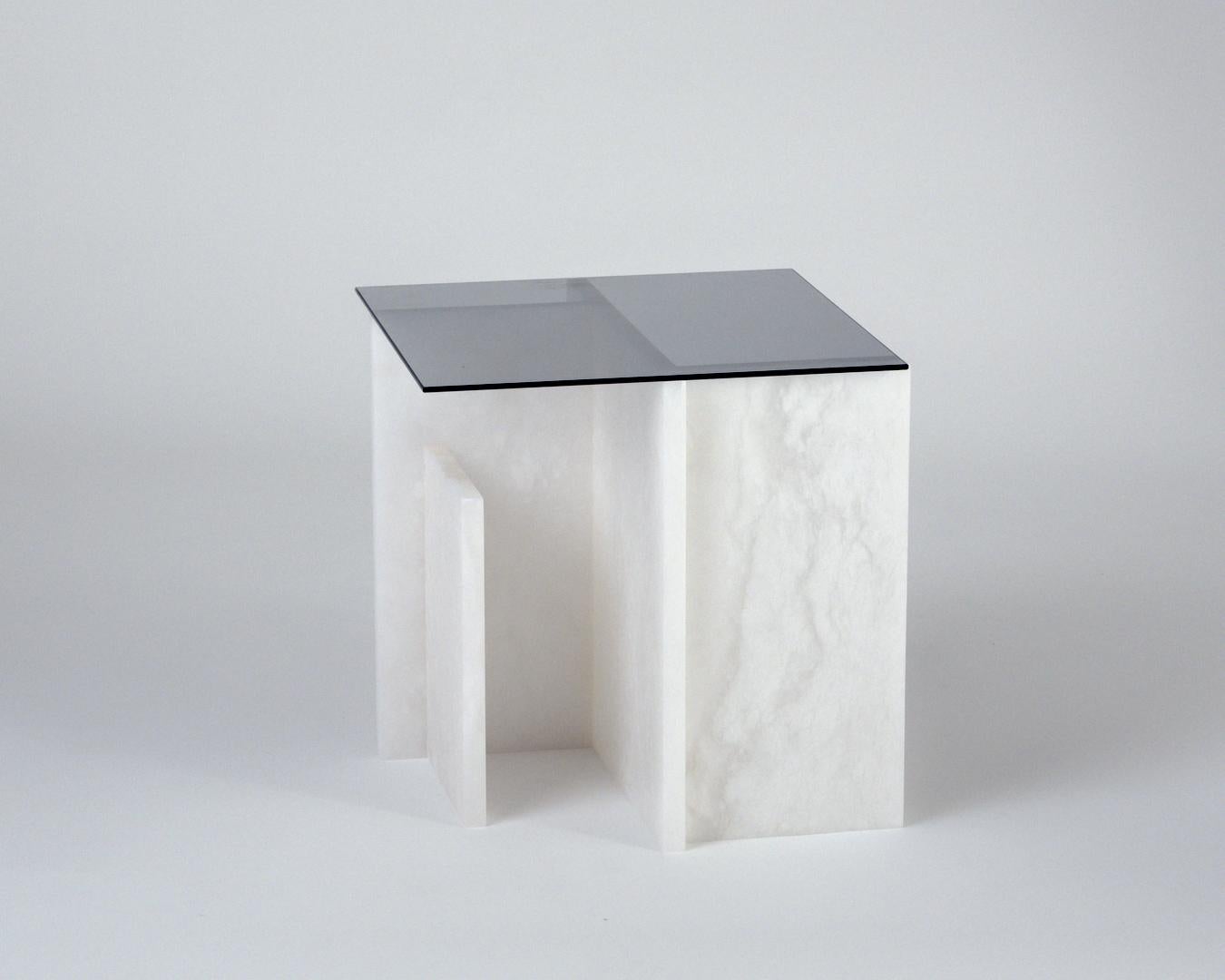 Alabaster table by Owl
Dimensions: D 40 x W 40 x H 40cm
Materials: Solid Alabaster.

Alabaster is an evolving series in which alabaster is shaped into a functional play of vertical, geometric forms. The series has grown from early explorations