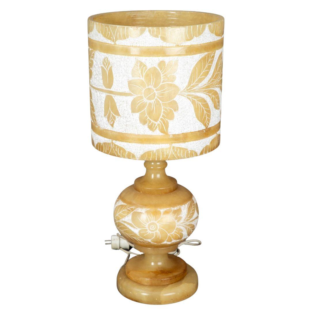 Esta lámpara de mesa de alabastro tiene un robusto soporte y un paraguas, ambos adornados con intrincadas decoraciones florales. Está en buen estado, con mínimas señales de uso y es totalmente funcional. La lámpara proporciona una luz cálida y