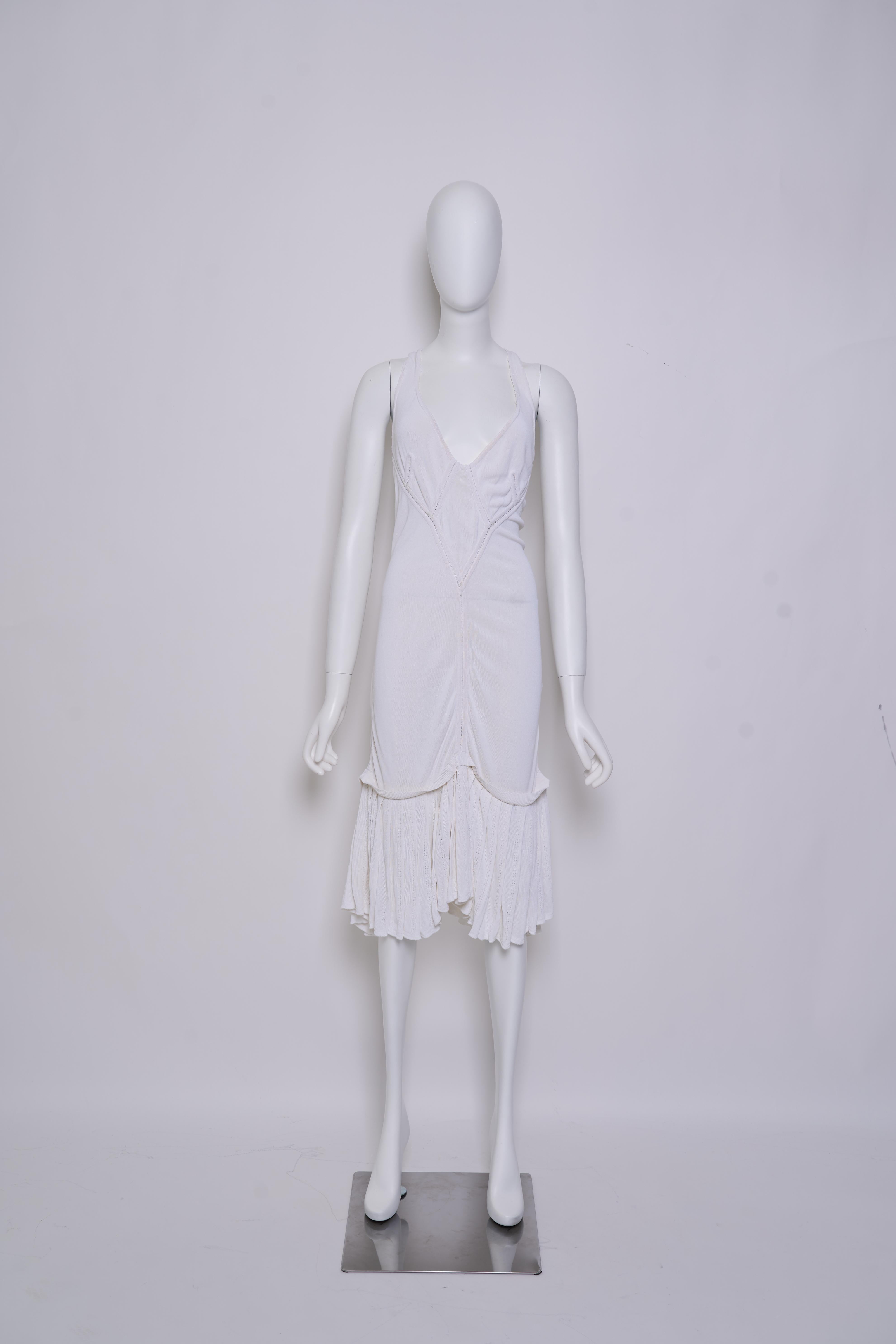 Piece Description: Vintage Alaïa white drop-waist dress from the 1980s. This mid-length piece features a deep neckline and a relaxed, drop-waist silhouette that reflects Alaïa’s signature balance of sophistication and sensuality.

Designer