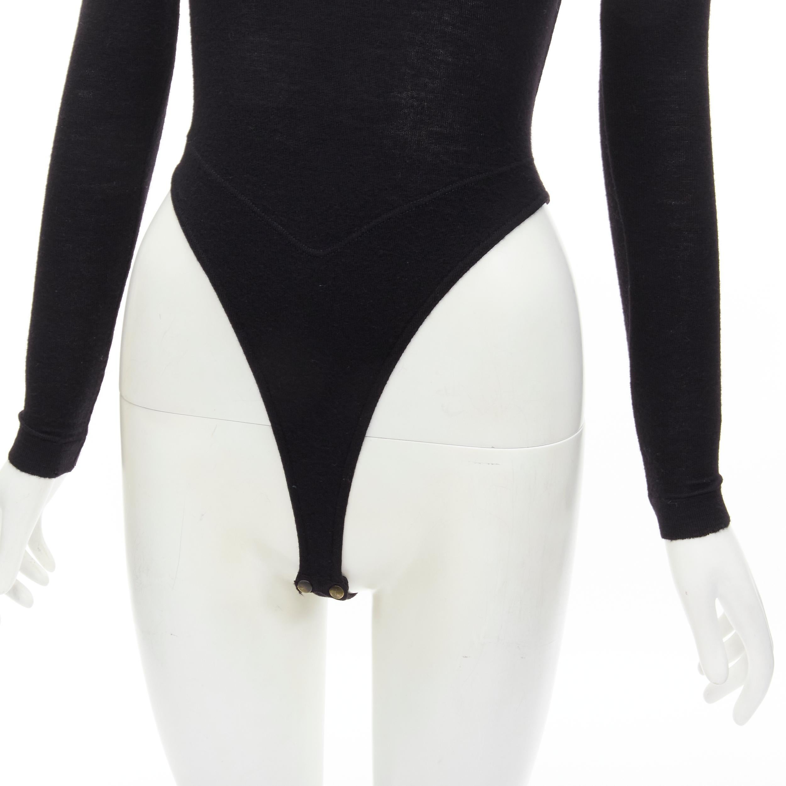 ALAIA 1990's Vintage black wool mock neck long sleeve high cut bodysuit top M 
Reference: TGAS/C01256 
Brand: Alaia 
Designer: Azzedine Alaia 
Collection: 1990's 
Material: Wool 
Color: Black 
Pattern: Solid 
Closure: Snap button 
Extra Detail: Mock