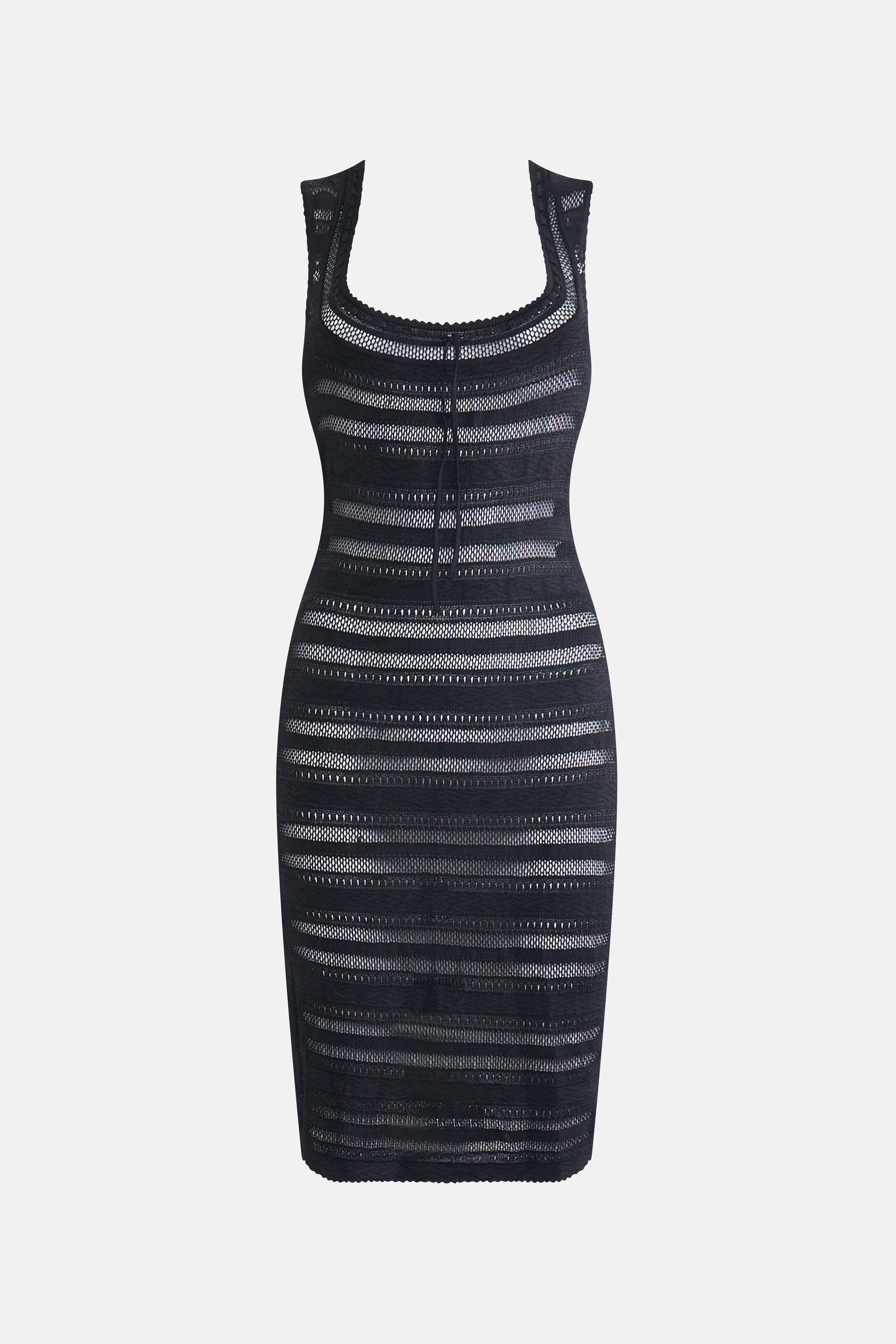 Vintage Alaia 1993 sheer crochet dress. This black semi-sheer bodycon dress features open knit paneling and a sleek, fitted silhouette. The scoop neck is adorned with a tonal bow detail for a touch of elegance.

Size M
Condition B, light signs of