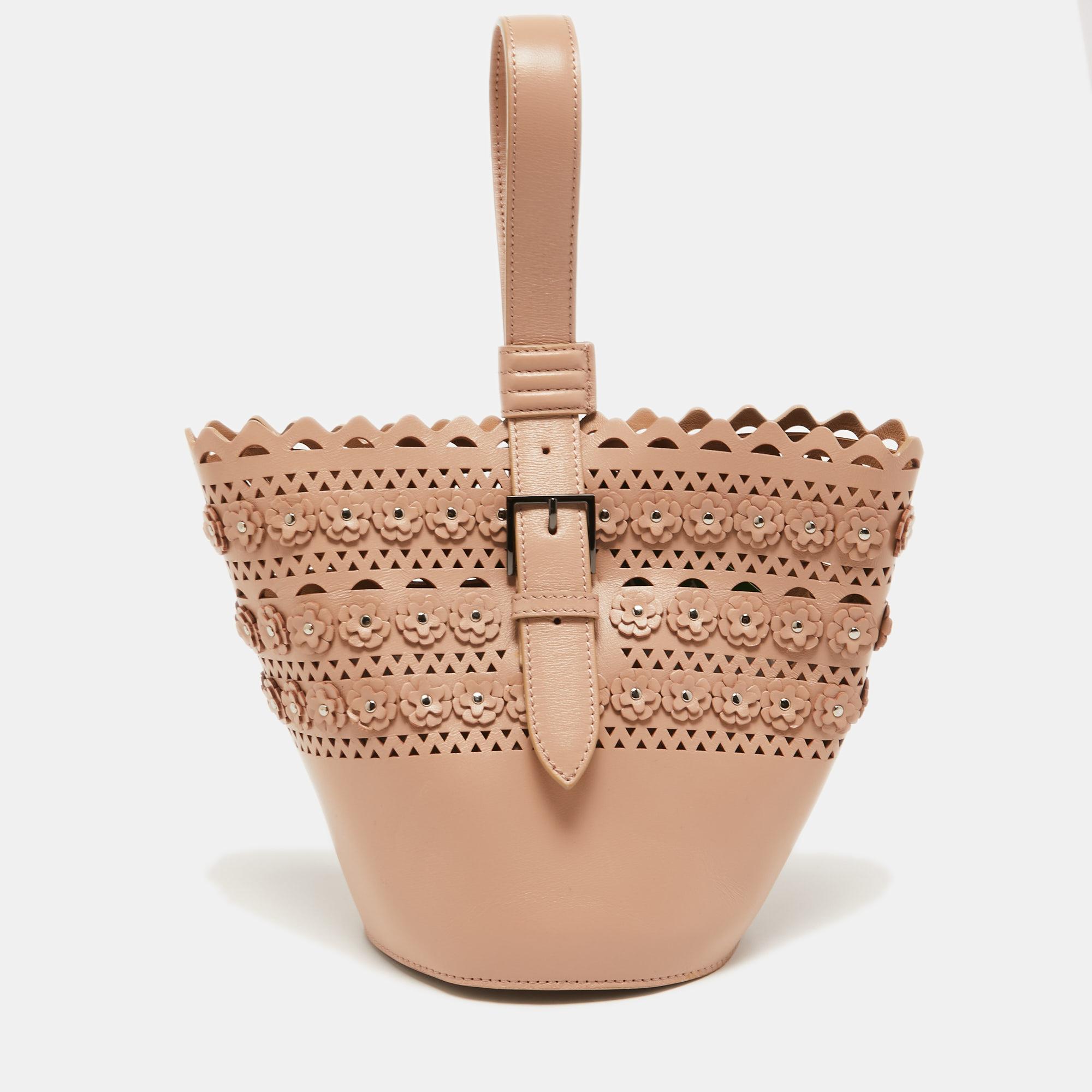 We bring you this carefully-designed bag, crafted with love using leather. It arrives in a bucket shape and is designed with a single buckled handle and a spacious interior. The beige bag by Alaia is durable and fashionable.

