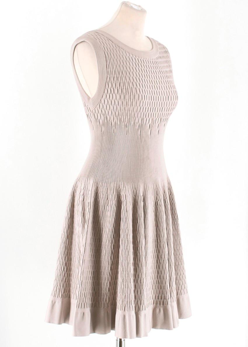 Alaia Beige Stretch Knit Dress

-Beige stretch knit dress 
-Classic fit and flare silhouette
-Back zip closure
-Scoop neckline

Please note, these items are pre-owned and may show signs of being stored even when unworn and unused. This is reflected