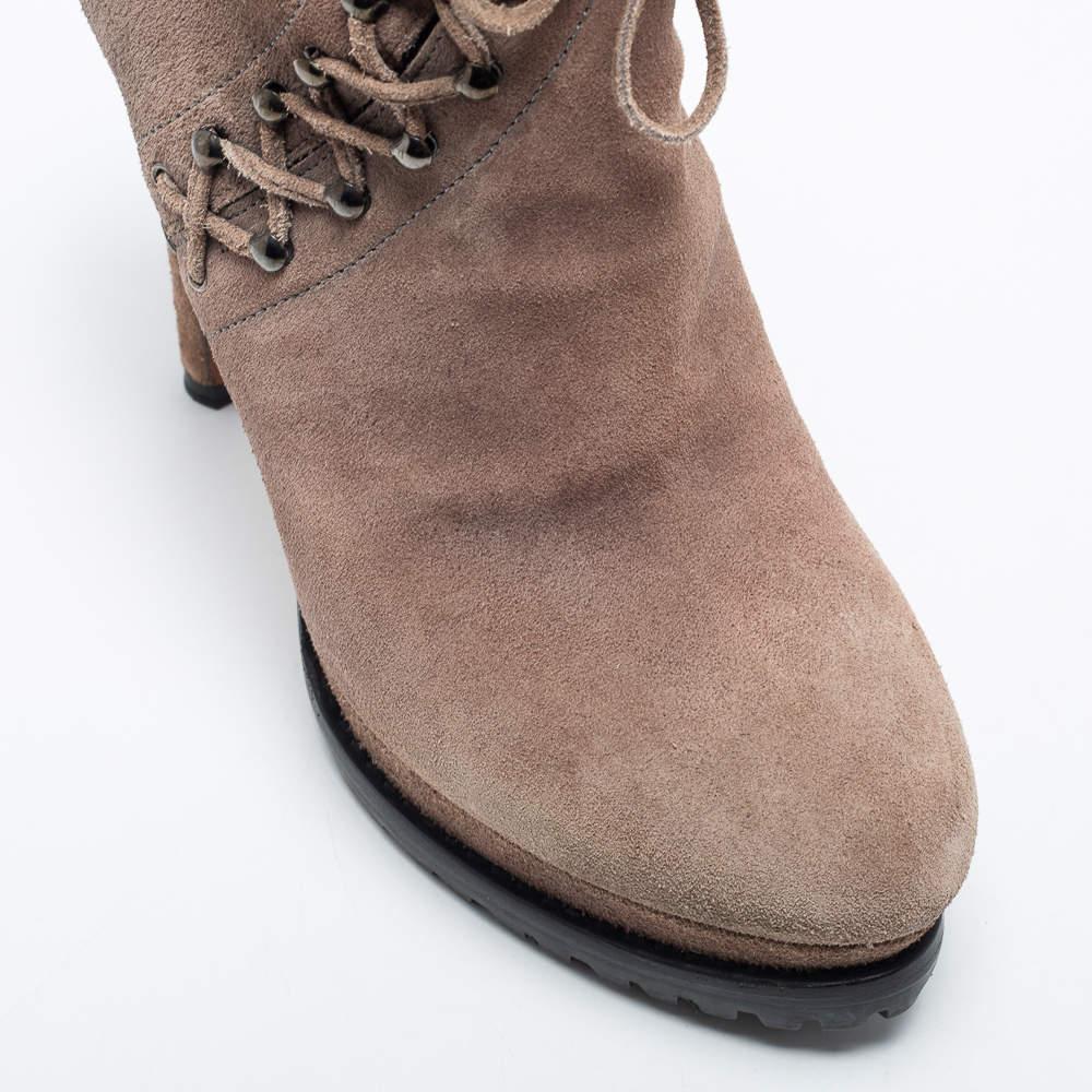 Fashionable and uber-chic, these statement beige booties from Alaia will cut an alluring silhouette from day to night. Crafted from suede, they feature lace-ups, sturdy platforms, and 13.5 cm heels.

