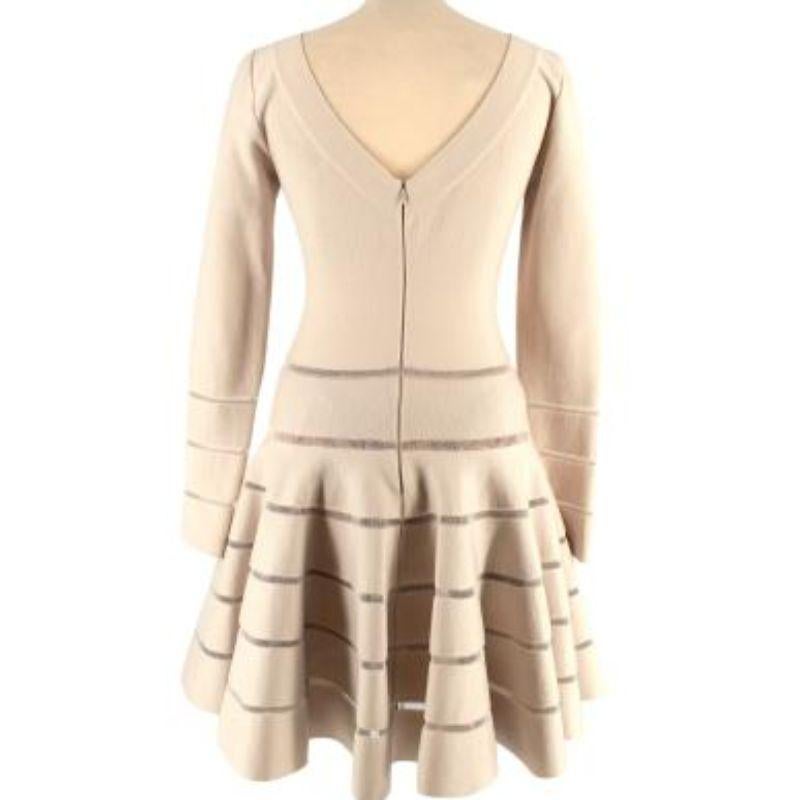 Alaia Beige Wool Blend Knit Skater Dress

- Long sleeved wool blend beige dress with sheer stripe details 
- Skater silhouette with flared skirt 
- Scoop neck and low back with concealed zip down the back
- Mesh underskirt 
- Medium weight knit