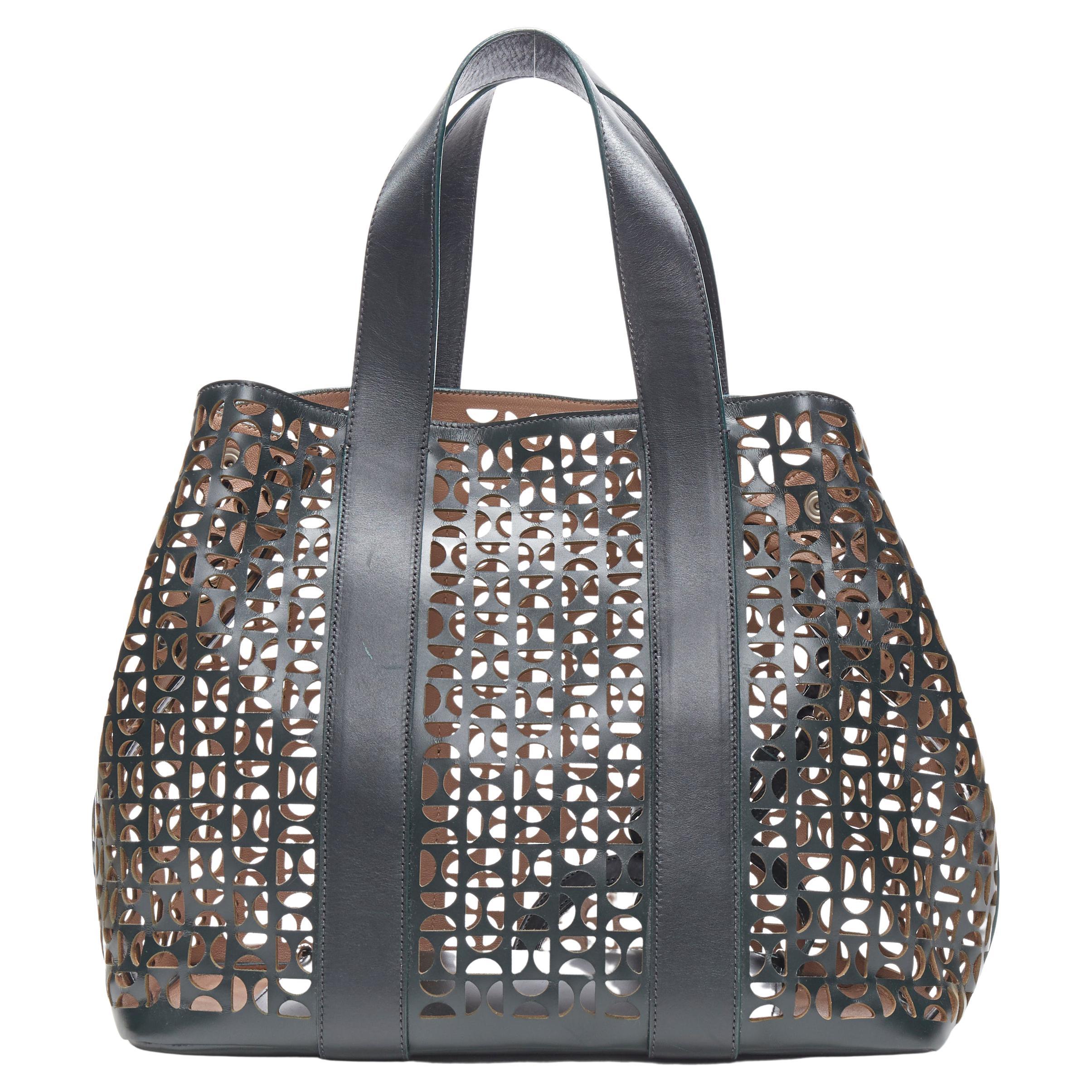 ALAIA black geometric cut out leather expandable sides zip pocket top handle bag