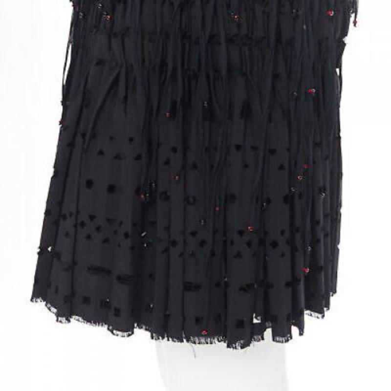 ALAIA black geometric cut out pleated shirred red bead fringe skirt FR38 M
Reference: TGAS/A00415
Brand: Alaia
Designer: Azzedine Alaia
Material: Wool
Color: Black
Pattern: Geometric
Closure: Zip
Extra Details: Red beaded fringe. Raw frayed hem.
