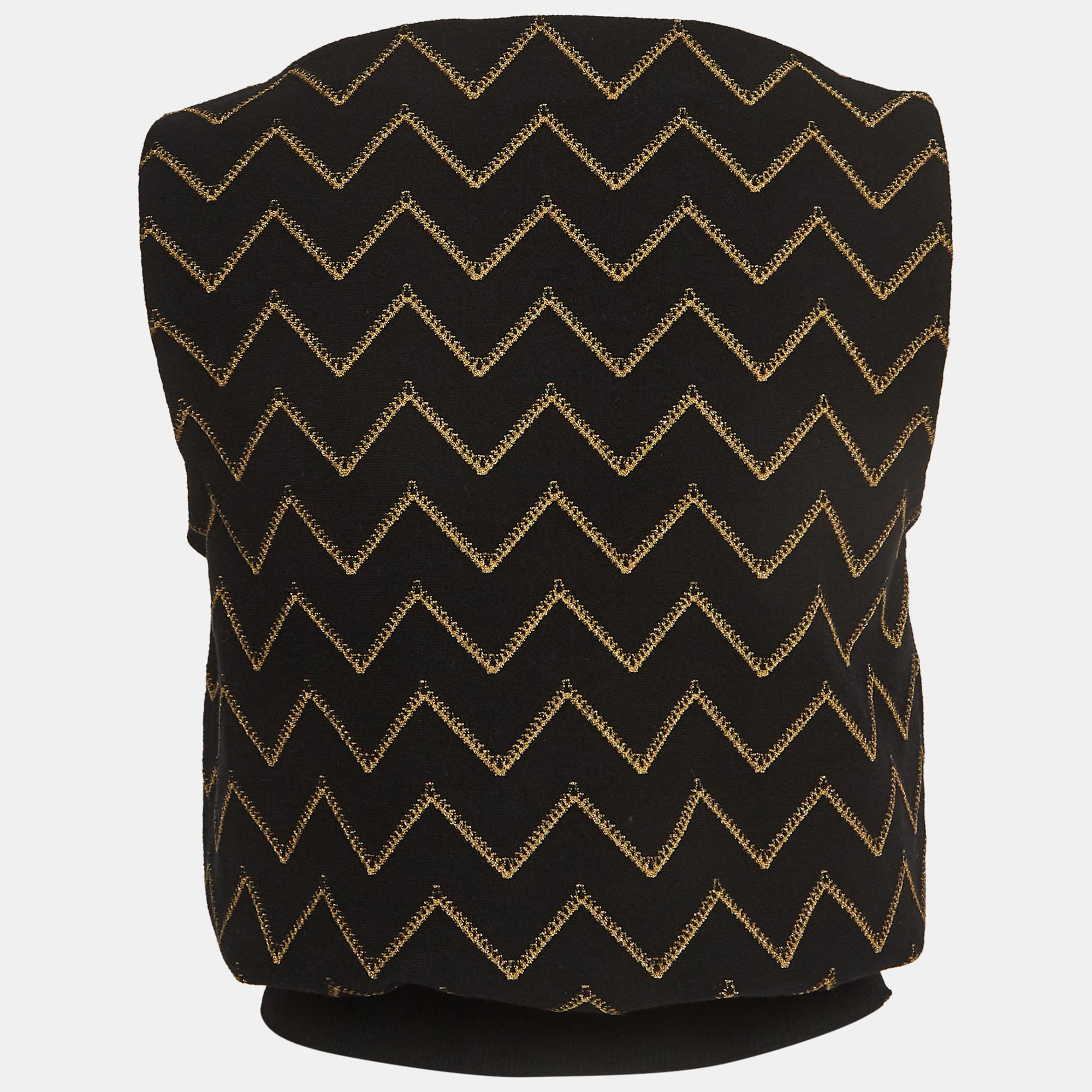 Introducing the Alaia vest, a stunning addition to your wardrobe. Crafted with meticulous detail, its intricate chevron pattern in black and gold exudes timeless charm. The lurex knit adds a touch of glamour, making it perfect for both casual