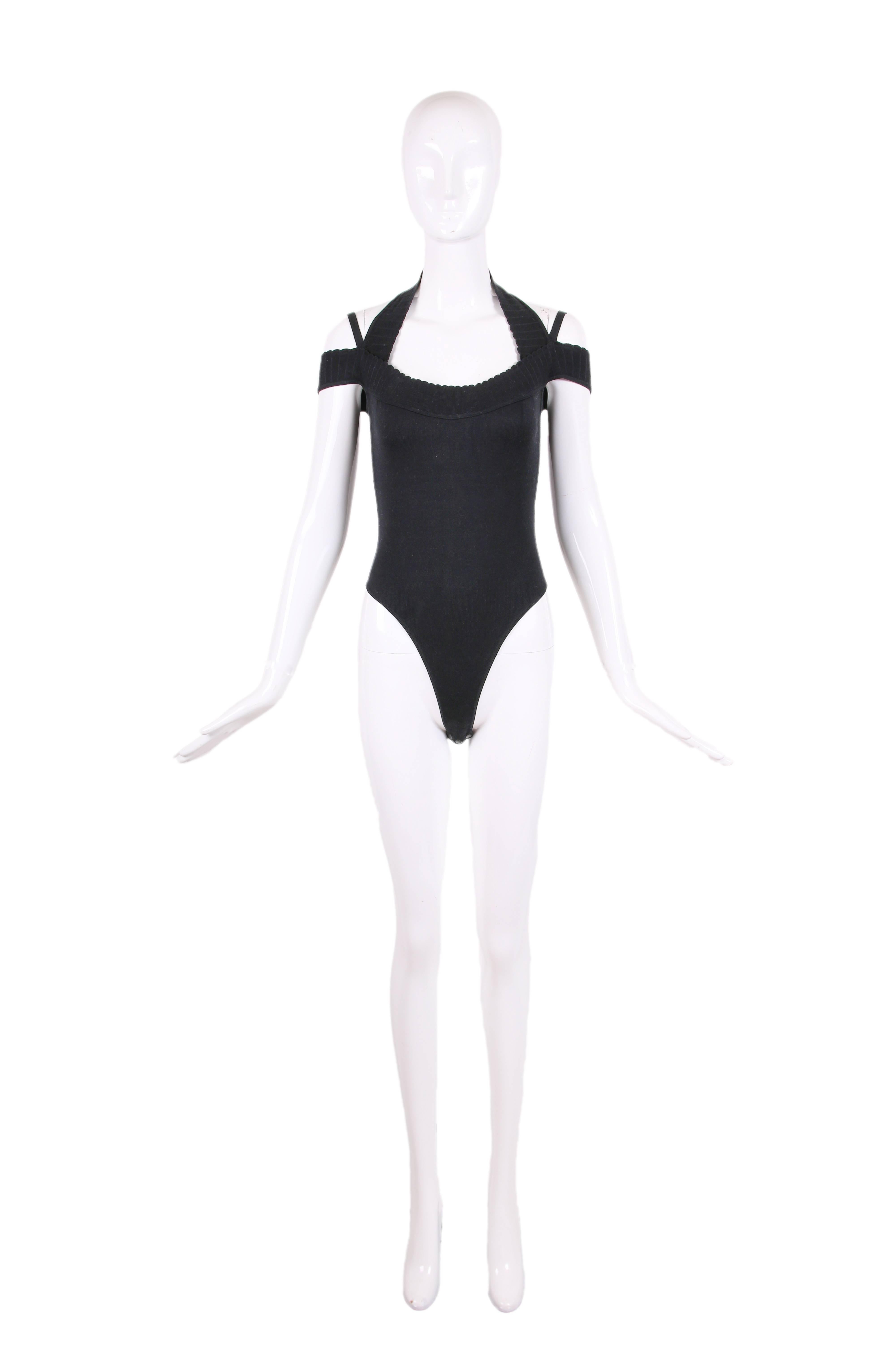 Vintage Alaia black cotton blend stretch bodysuit with scallop hem. This bodysuit features a halter neck, spaghetti strap, and off-the-shoulder sleeve. In excellent condition. Size S. 
MEASUREMENTS:
Bust - 32