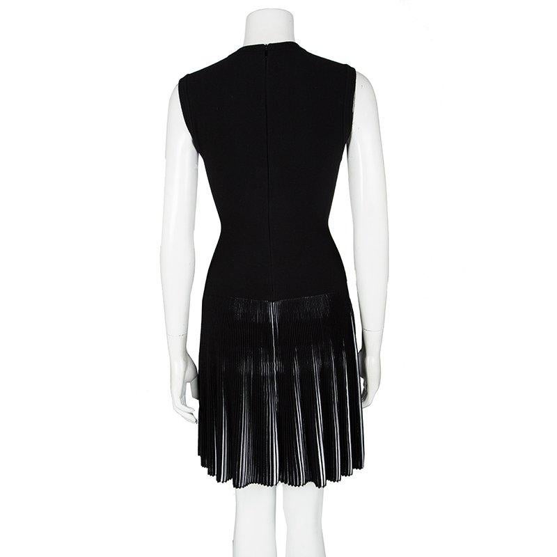 This dress from Alaia is so pretty, you'll love flaunting it. The fabulous black creation is made of the finest materials and features an elegant silhouette. It carries a V neckline and accordion pleats on the bottom half. Pair it with beige sandals