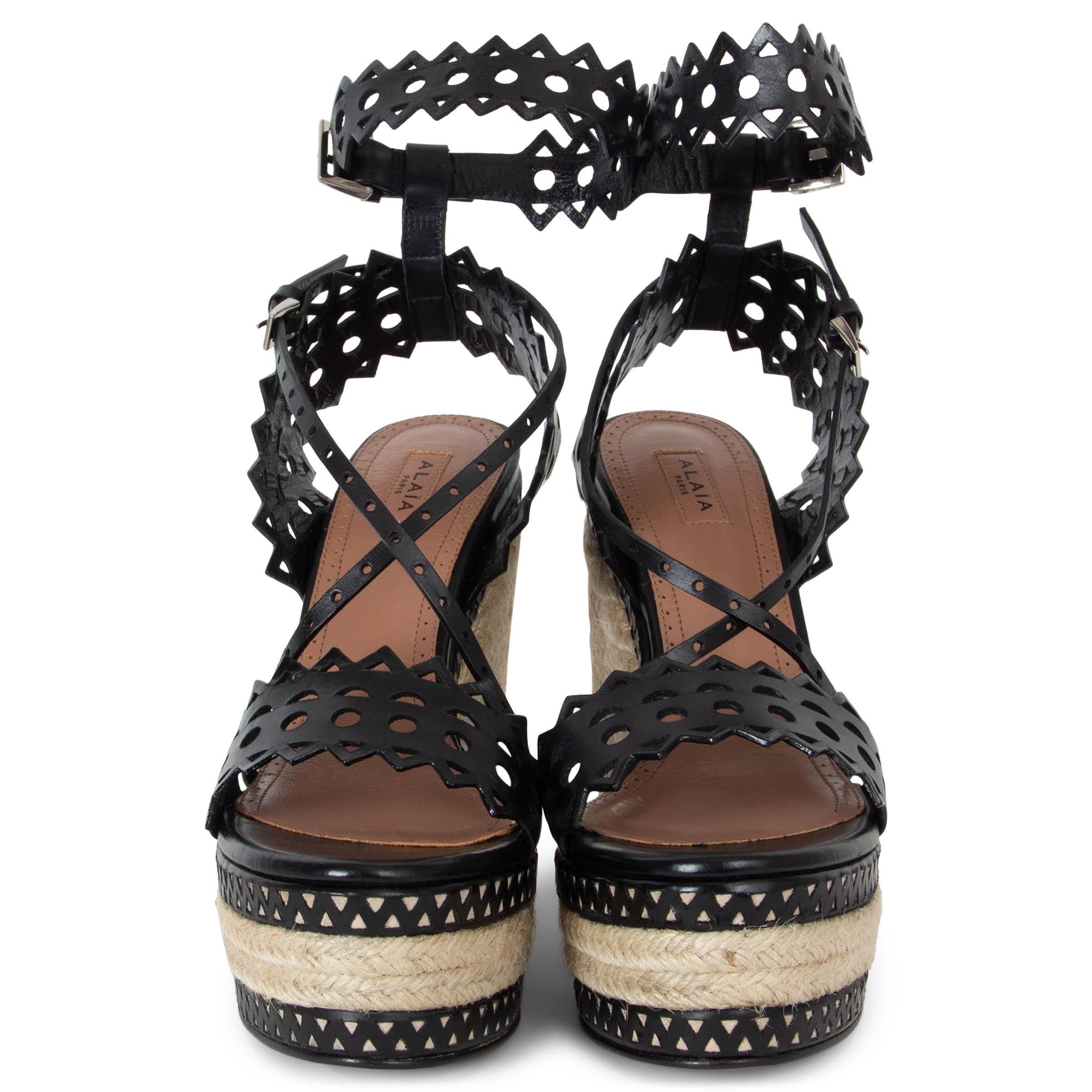 These 100% authentic Alaïa laser cut leather platform espadrille wedges exude effortless sophistication and chic style. Featuring intricate laser-cut detailing in black leather, these wedges are a striking blend of craftsmanship and elegance. The