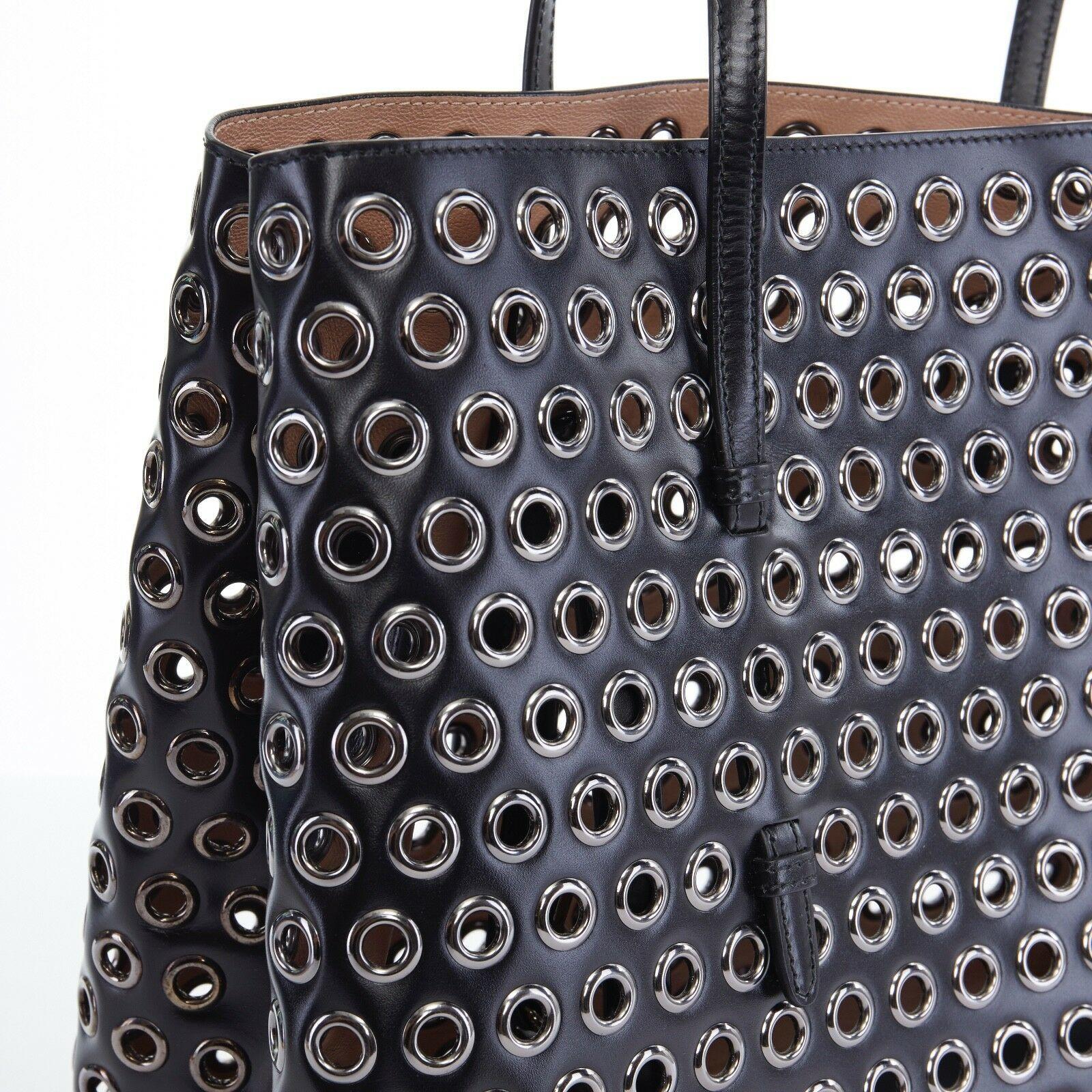 ALAIA black leather gunmetal grommet stud top handle expandable large tote bag In Excellent Condition In Hong Kong, NT