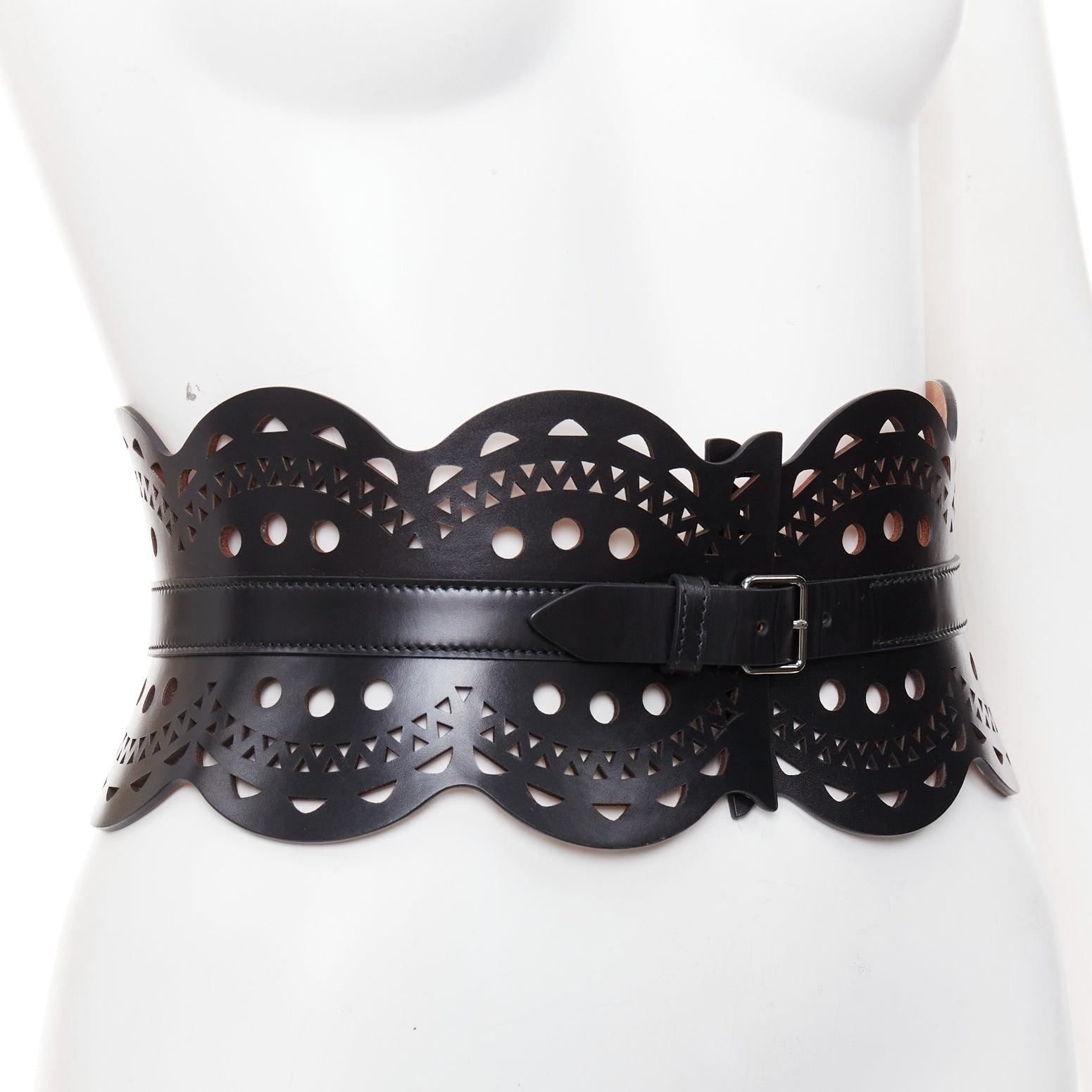 ALAIA black leather laser cut out scalloped wide statement corset belt 65cm
Reference: SNKO/A00628
Brand: Alaia
Material: Leather
Color: Black, Silver
Pattern: Solid
Closure: Belt
Lining: Nude Leather
Made in: Italy

CONDITION:
Condition: Good, this