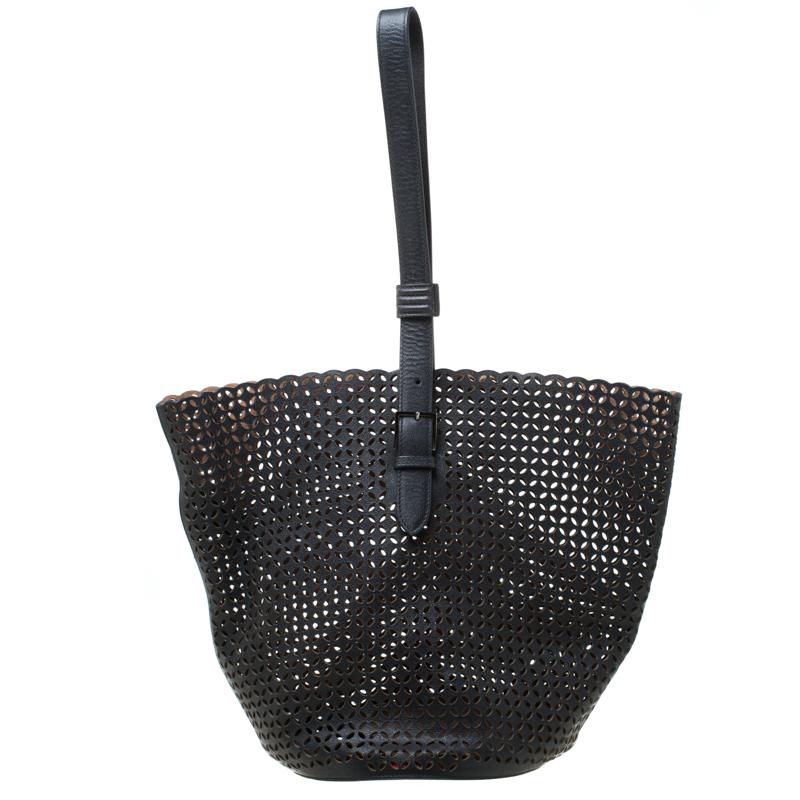 We bring you this carefully-designed bag, crafted with love using perforated leather. It arrives in a bucket shape and is designed with a single buckled handle and a spacious interior. The black bag by Alaia is durable and fashionable.

Includes: