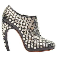 ALAIA black leather silver square stud embellished curved heel bootie EU38