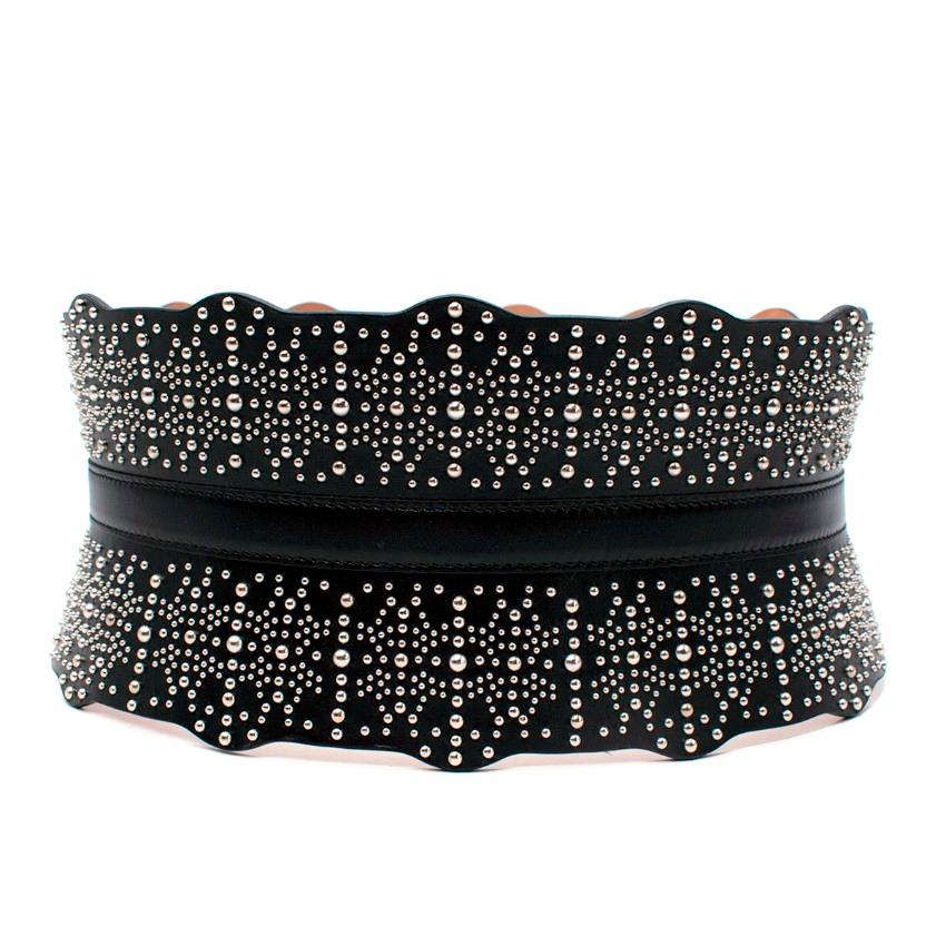 Alaia Black Leather Studded Corset Belt

- Signature Alaia design, featuring a deep corset-style shape designed to cinch the waist
- Silver-tone micro studs reference the knit patterns and laser cut leatherwork the brand is known for
- Scalloped