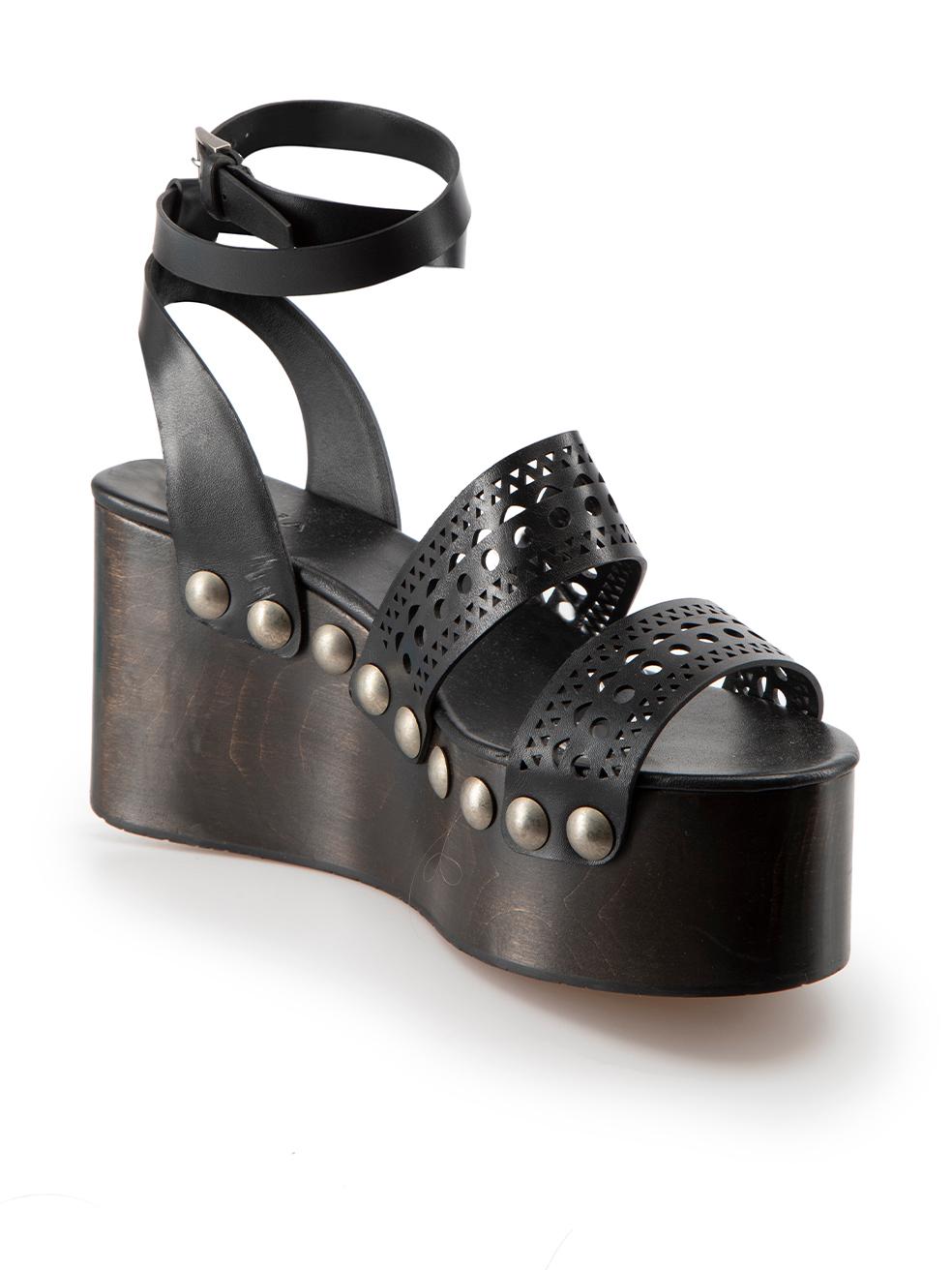 CONDITION is Very good. Minimal wear to sandals is evident. Minimal wear to wooden wedge with a number of negligible scuffs seen on this used Alaïa designer resale item.

Details
Black
Leather
Platform sandals
Studded
Cut-out straps
Adjustable ankle