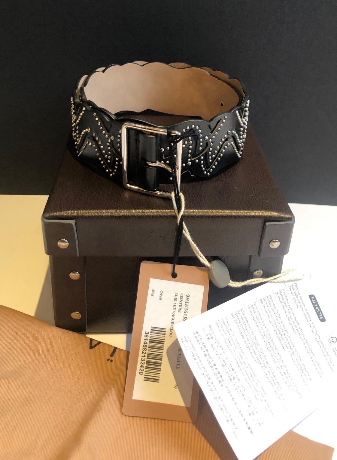 A luxury ALAIA PARIS  leather weave belt decorated with silver studded nails, a silver buckle with three adjustment holes. 

Condition: In very good condition, as new with label-tag, never used, lined with beige creamy leather suede style.  Made in