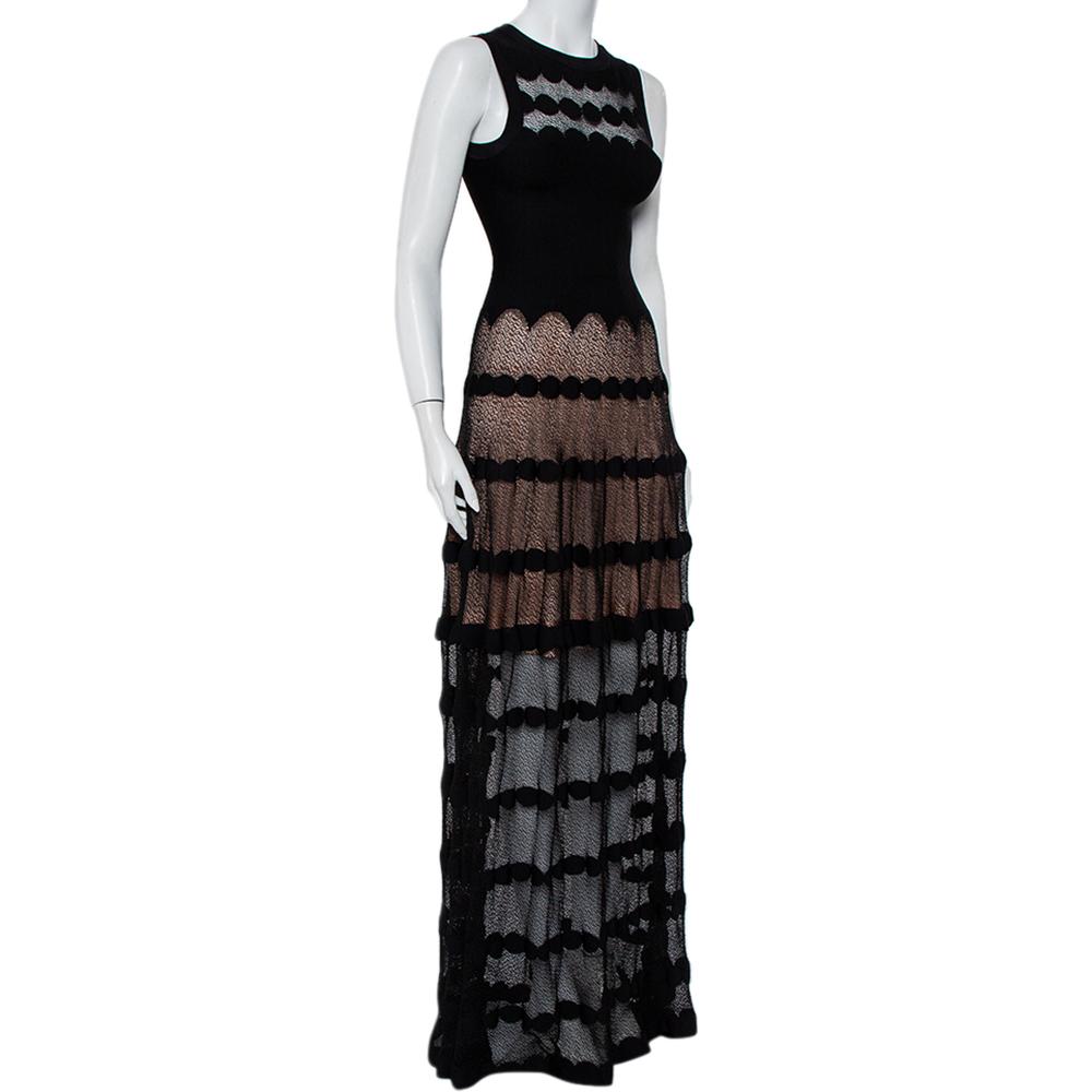 Wear this dazzling dress from the house of Alaia. The maxi dress is cut from a perforated knit material and presents itself in a shade of black. The sleeveless silhouette, the zip closure at the back and the fitted bodice all add a flattering