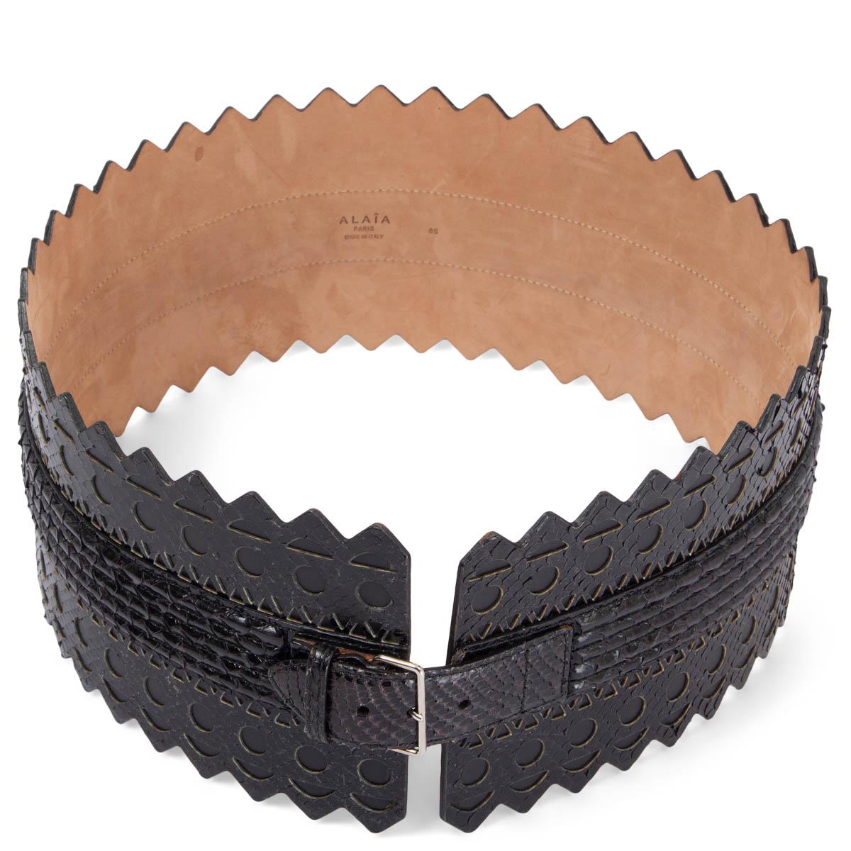 100% authentic Alaïa perforated laser-cut waist belt in black python and leather with one buckle closure in the middle. Has been worn and is in excellent condition. 

Measurements
Tag Size	85
Width	12cm (4.7in)
Fits	83cm (32.4in) to 87cm