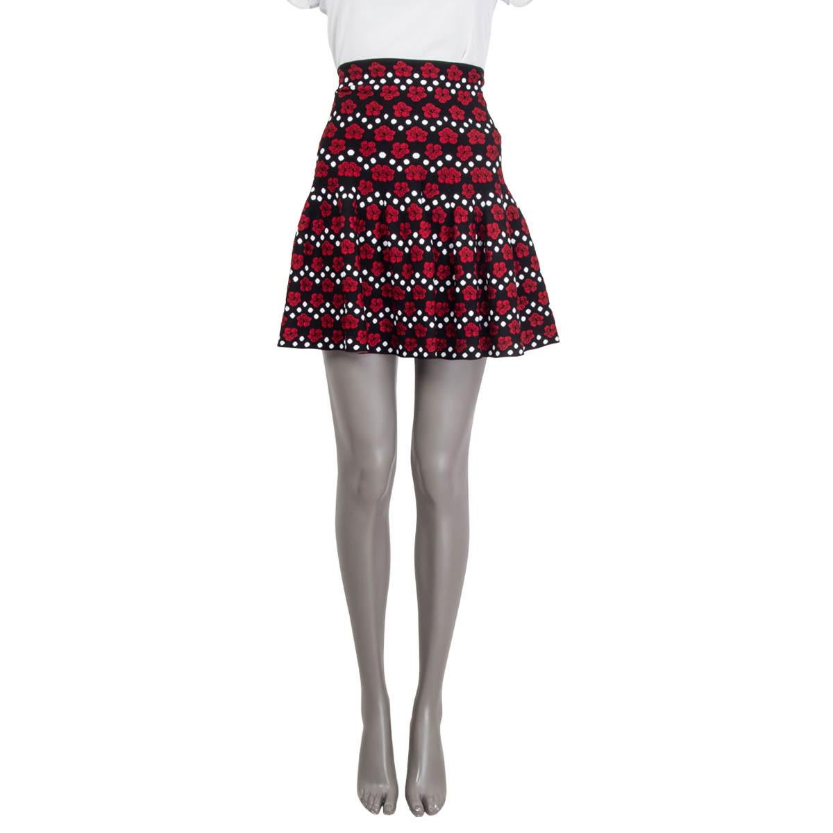 100% authentic Alaia jacquard knitted high waisted mini skirt in black, red and white viscose (78%), polyester (13%), nylon (7%) and elastane (2%). Features a floral and polka dot print. Opens with hook and a concealed zipper at the back. Unlined.