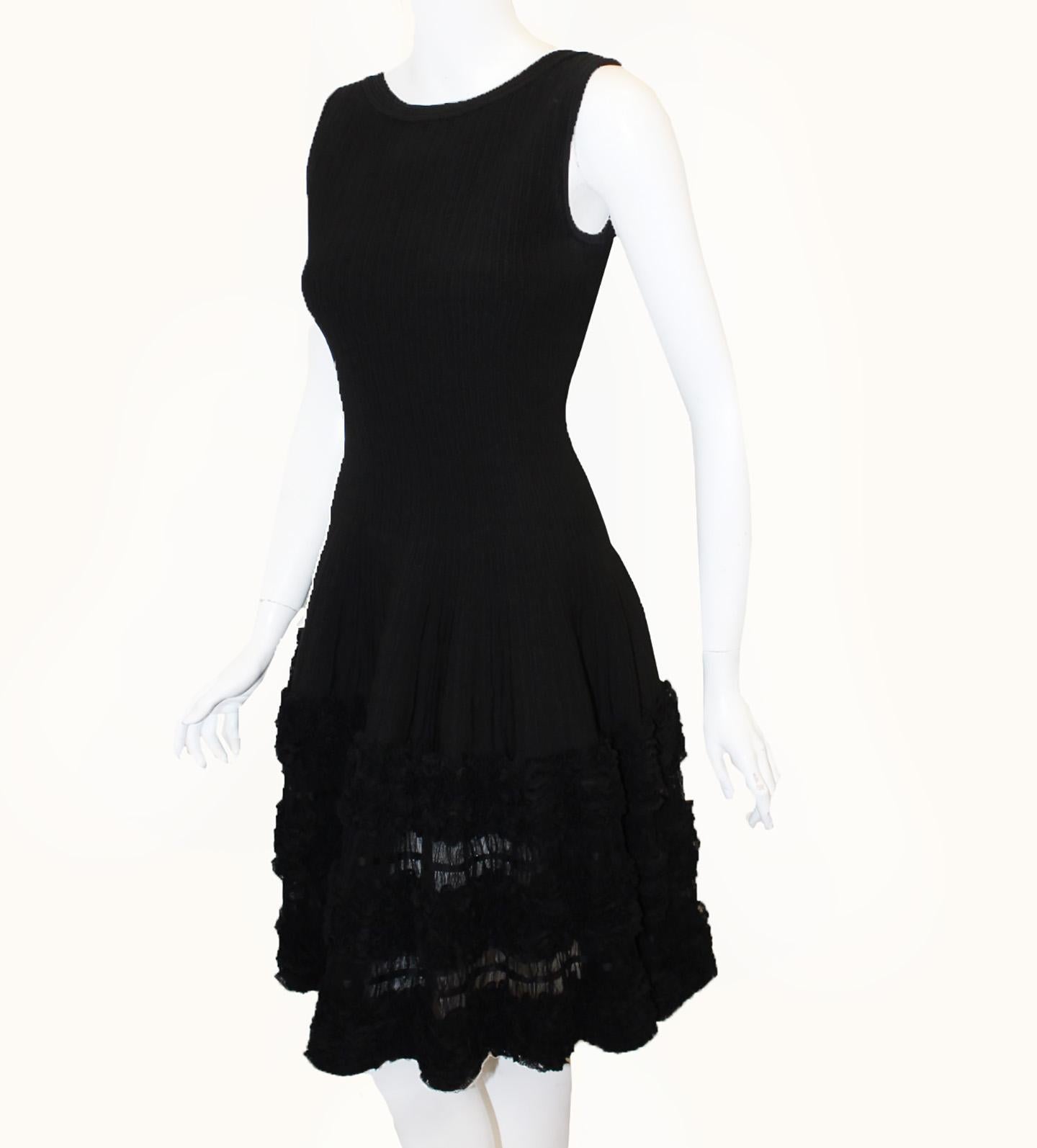 Alaïa's black sleeveless silk blend dress radiates sexiness with the low cut back and with the layered lace ruffle ballerina style appliques, this flirty dress reflects your feminine aesthetic!  This dress is not lined.  It is in excellent
