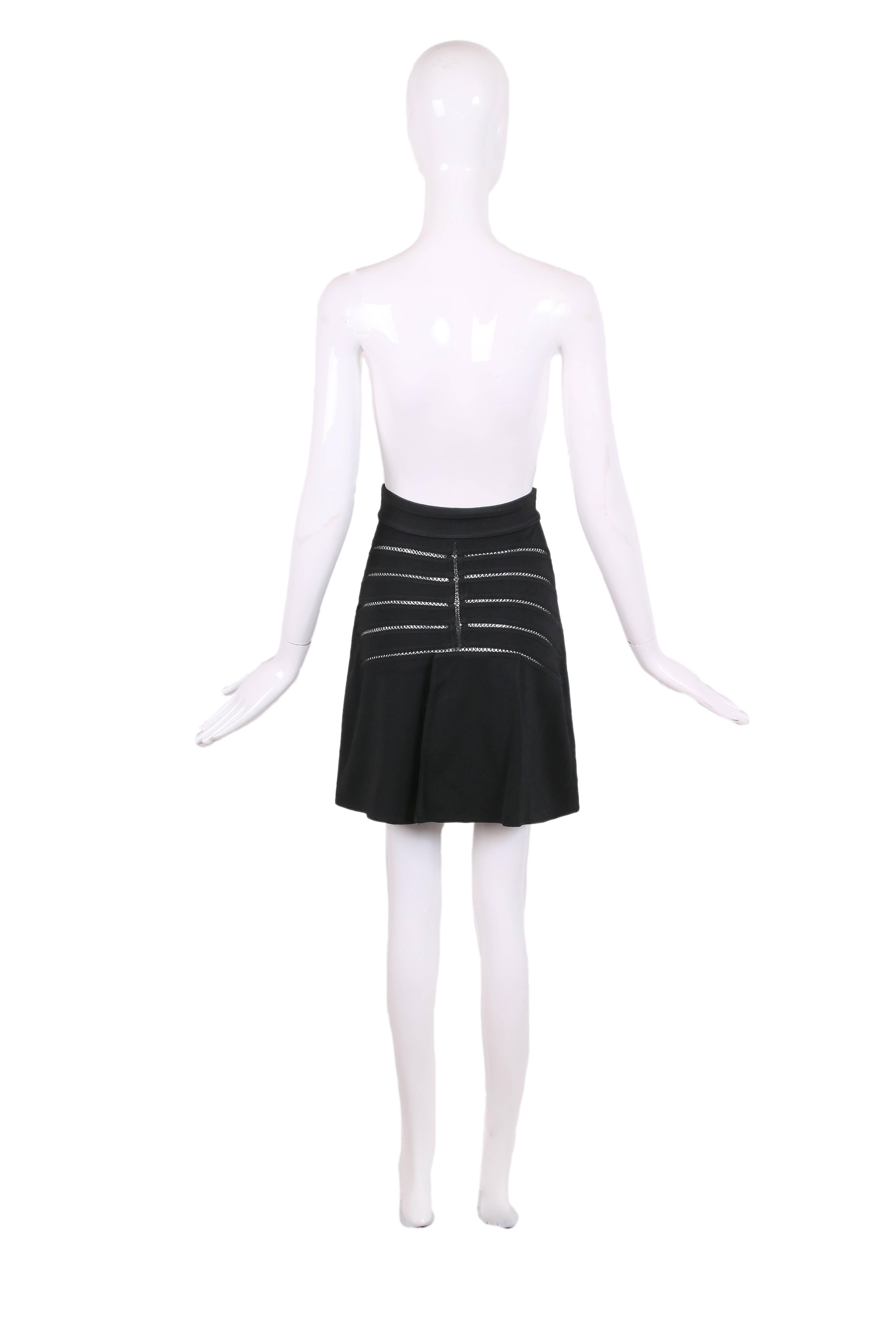 Vintage Alaia black stretch A-line mini skirt featuring crochet detail and cut-outs down center front and at back. Stretch waist. In excellent condition. Size S.
MEASUREMENTS:
Waist - 24-26