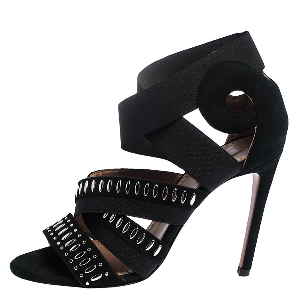 Wear these stylish sandals from the house of Alaia and channel your inner fashionista. These black sandals are the epitome of elegance and poise. They have been crafted from suede and elastic bands. They have peep toes, crisscross straps, high