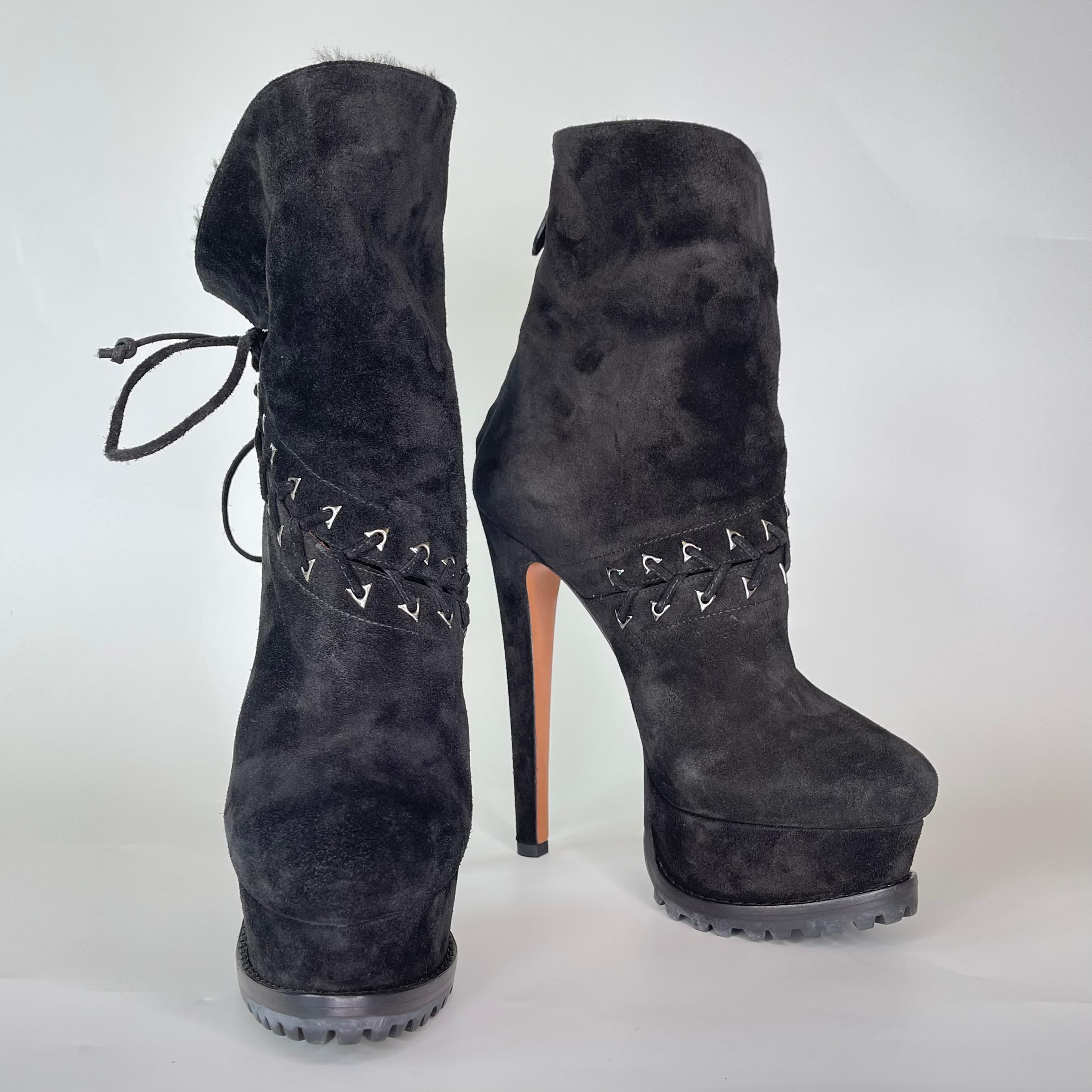 As seen on Ariana Grande! These glamorous hiking boots have an exterior of black suede and feature lace up fastening, triangular silver-toned eyelets, fur lining, round toe, stiletto heel, covered heel and rubber and leather soles.

COLOR: