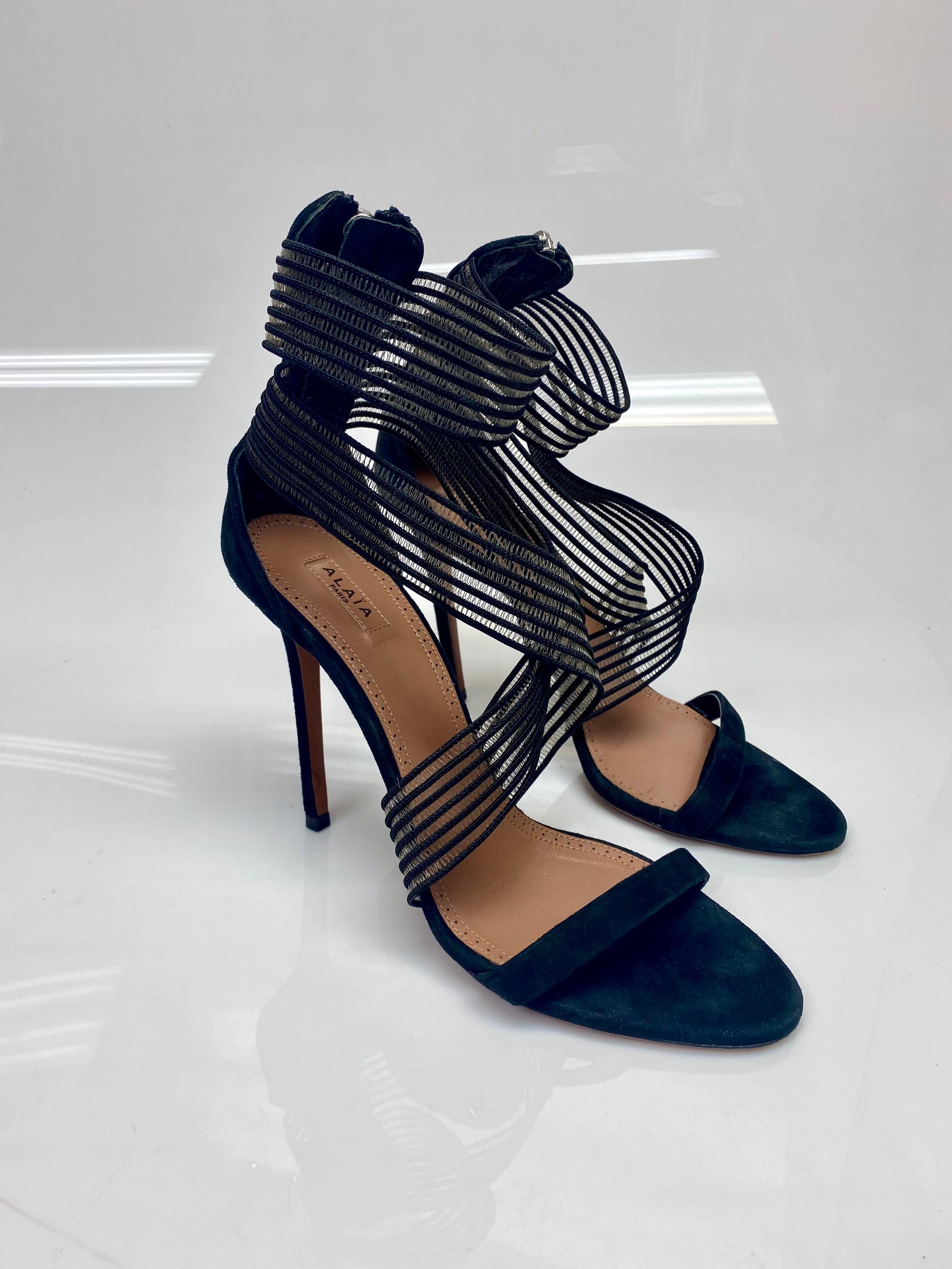 Alaia Black Suede Ribbon Sandals Heels Size 40. Azzedine Alaïa suede ribbon sandals have been crafted in Italy from black suede and finished with a beautiful striped detailing around the middle, and top of the shoe to compliment any outfit. Item is