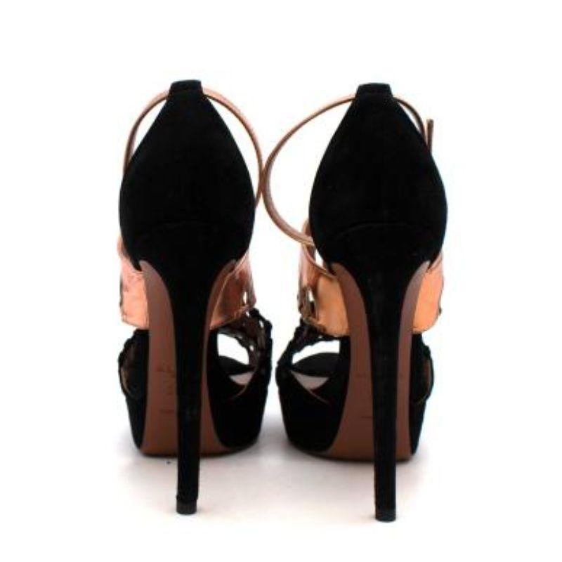 Alaia Black Suede & Rose Gold Leather Platform Heeled Sandals 
 

 - Black suede and metallic rose gold leather heeled sandals 
 - Cut out detail on the straps 
 - Rose gold ankle strap with buckle 
 - Black suede platform sole and stiletto heel
 -