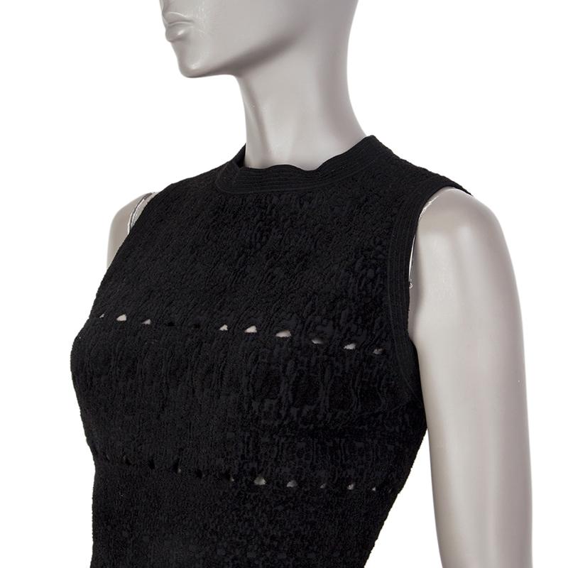 Alaia french terry perforated dress in black cupro (45%), viscose (35%), nylon (15%), and polyester (5%%). With crew neck and ruffled hemline. CLoses with invisible zipper on the back. Unlined. Has been worn and is in excellent condition. 

Tag Size